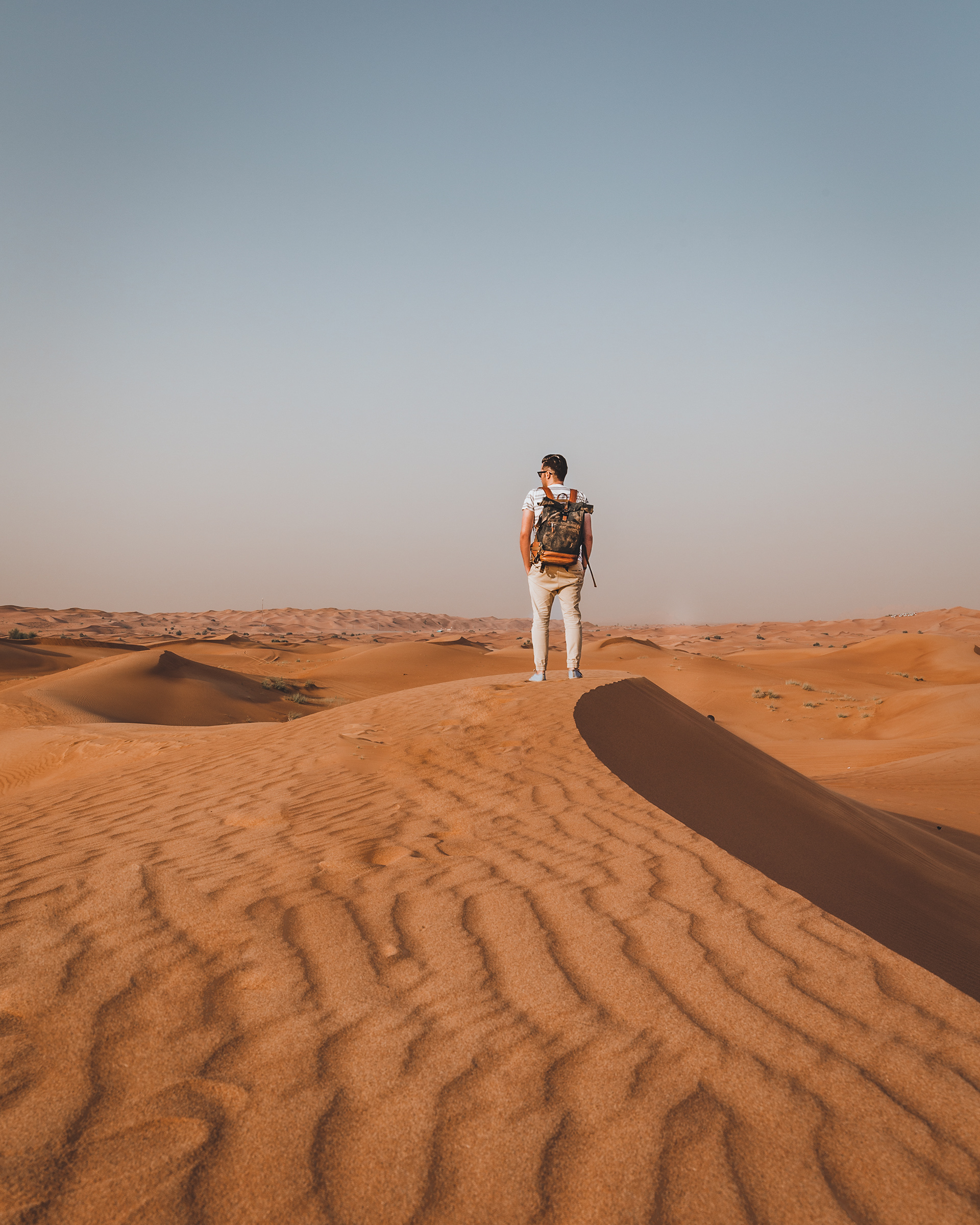 Photographer Manuel Bischof exploring the dunes of Dubai