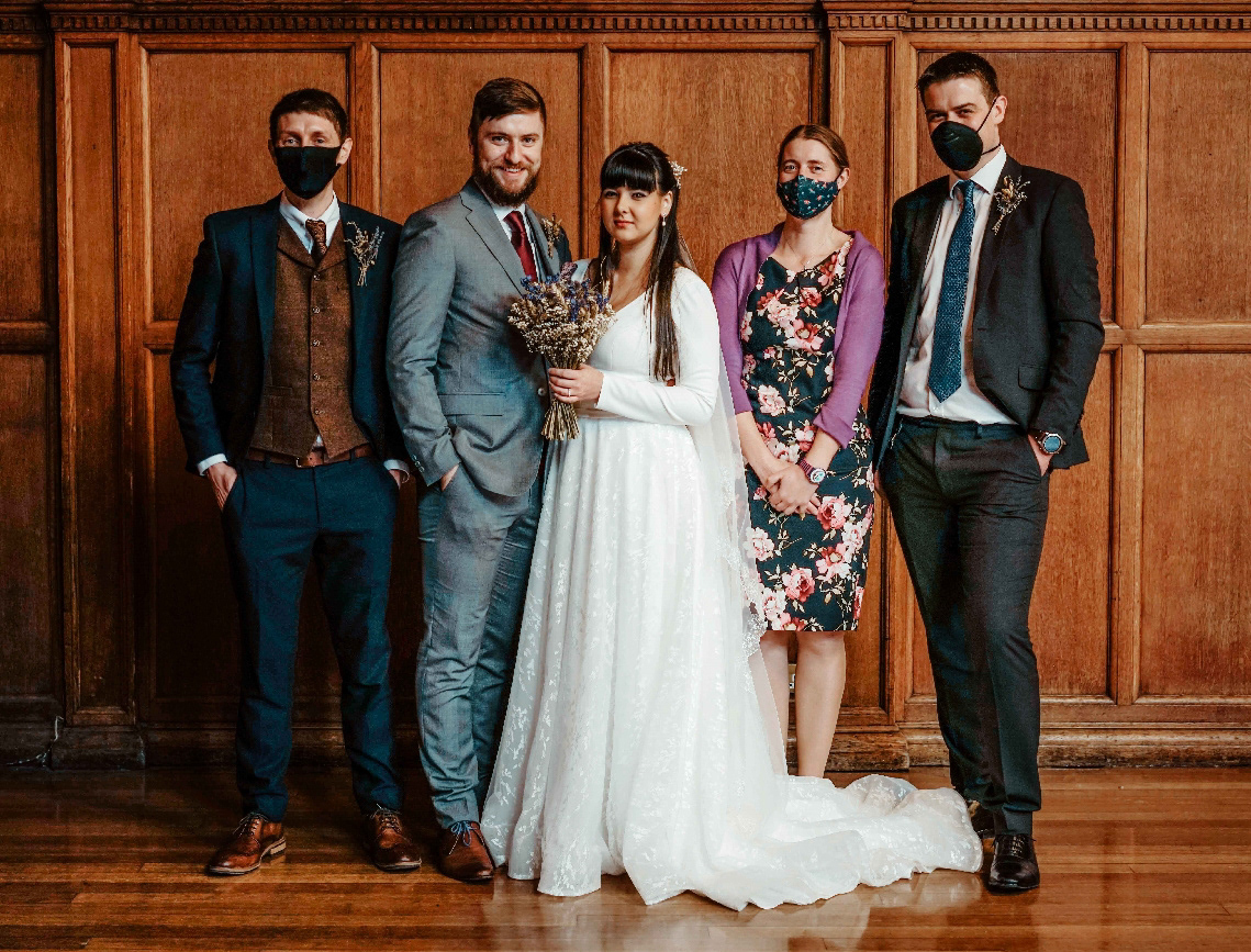 bride and groom stood with best man and family in small intimate covid wedding in december with david lefebvre wedding photographer