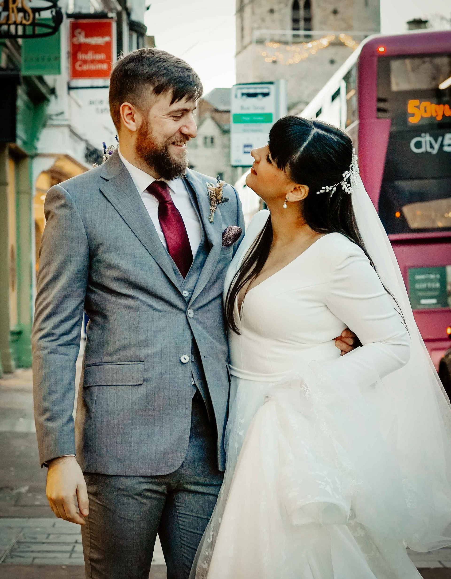 oxfordshire bride and groom smiling at each other at december covid wedding in oxford town in the streets with buckinghamshire photographer david lefebvre