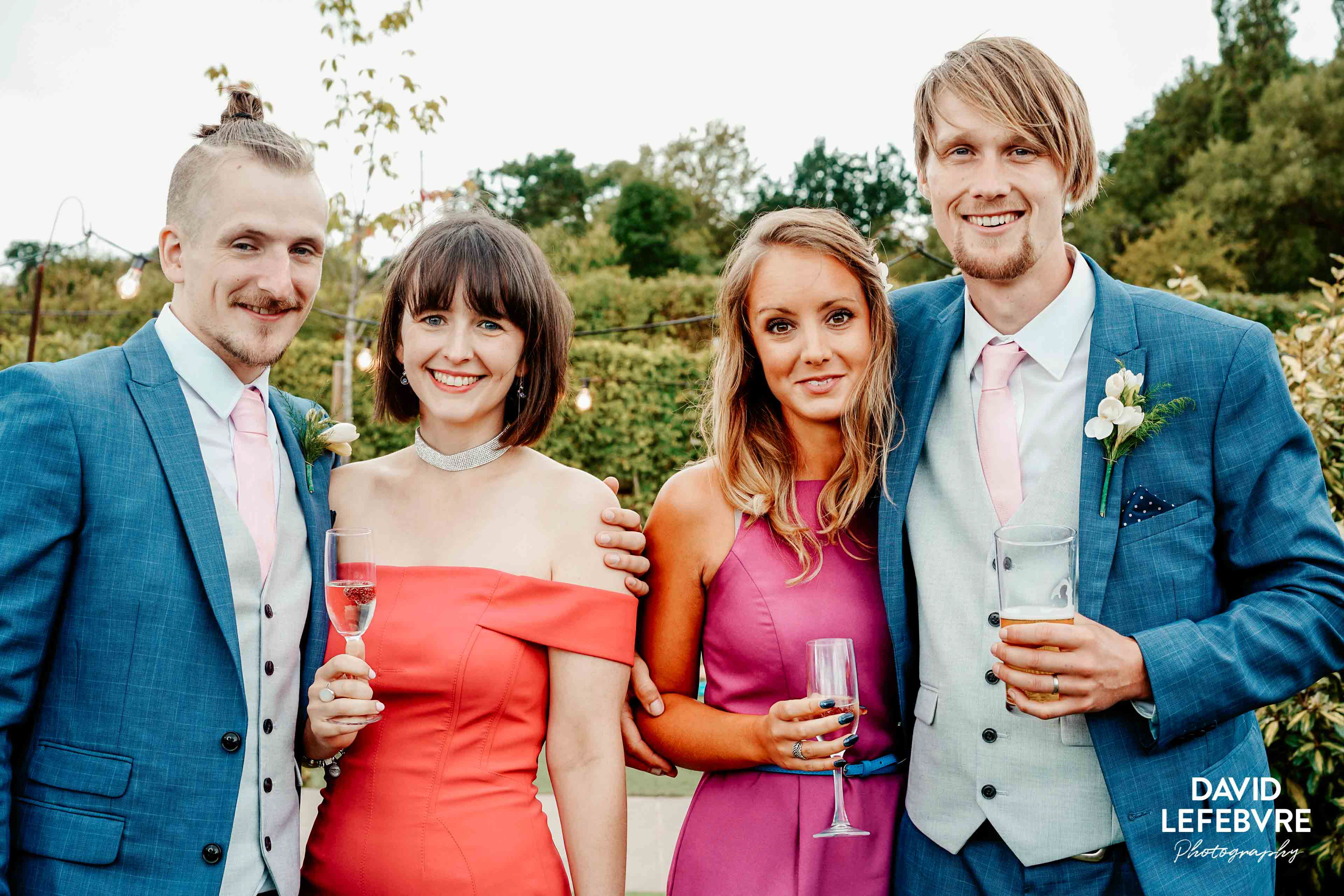 couples stood with drinks at owen barn house in cheshire