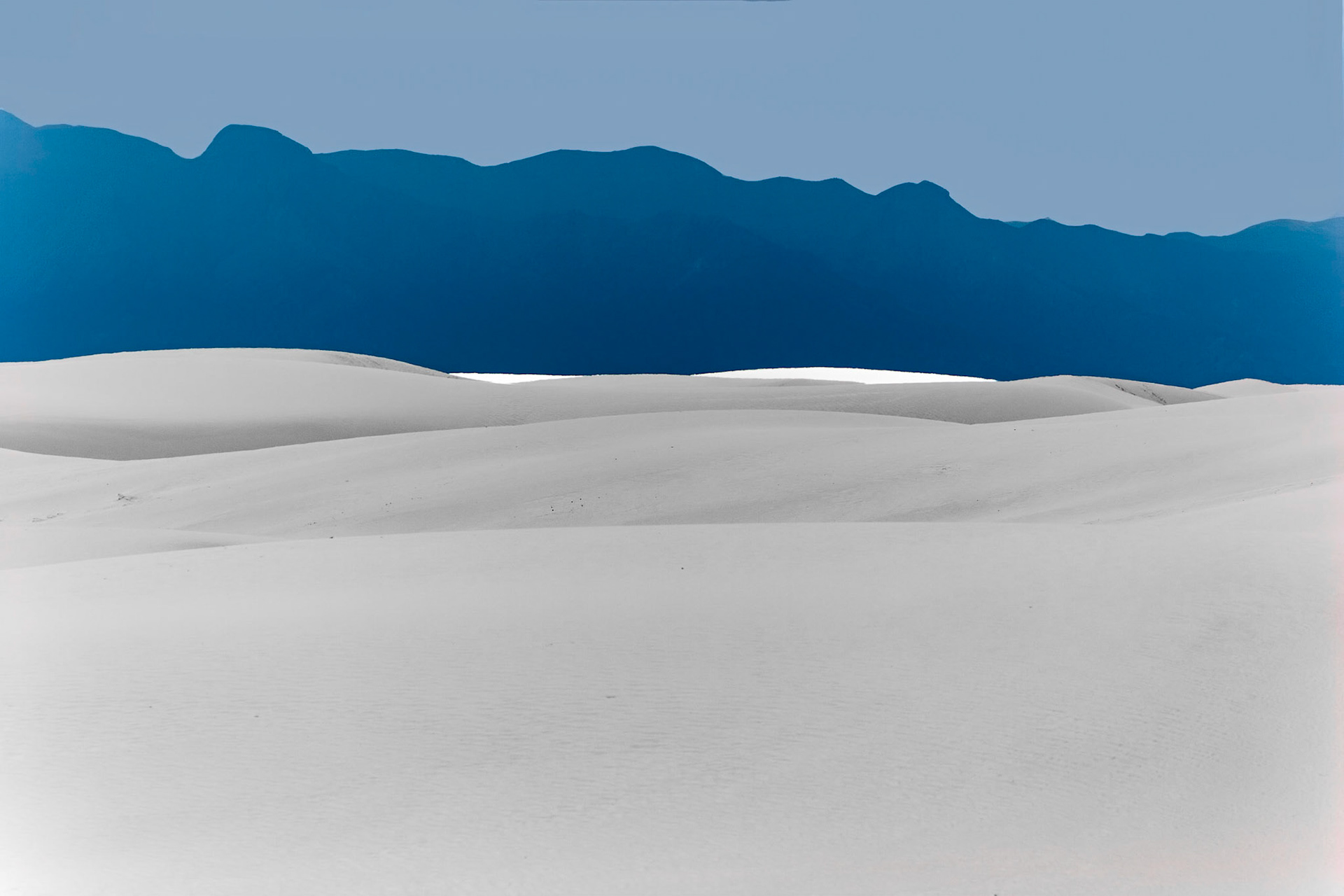 White Sands National Monument, New Mexico. Rising from the heart of the Tularosa Basin is one of the world's great natural wonders - the glistening white sands of New Mexico. Great wave-like dunes of gypsum sand have engulfed 275 square miles of desert, creating the world's largest gypsum dunefield. White Sands National Monument preserves a major portion of this unique dunefield, along with the plants and animals that live here.