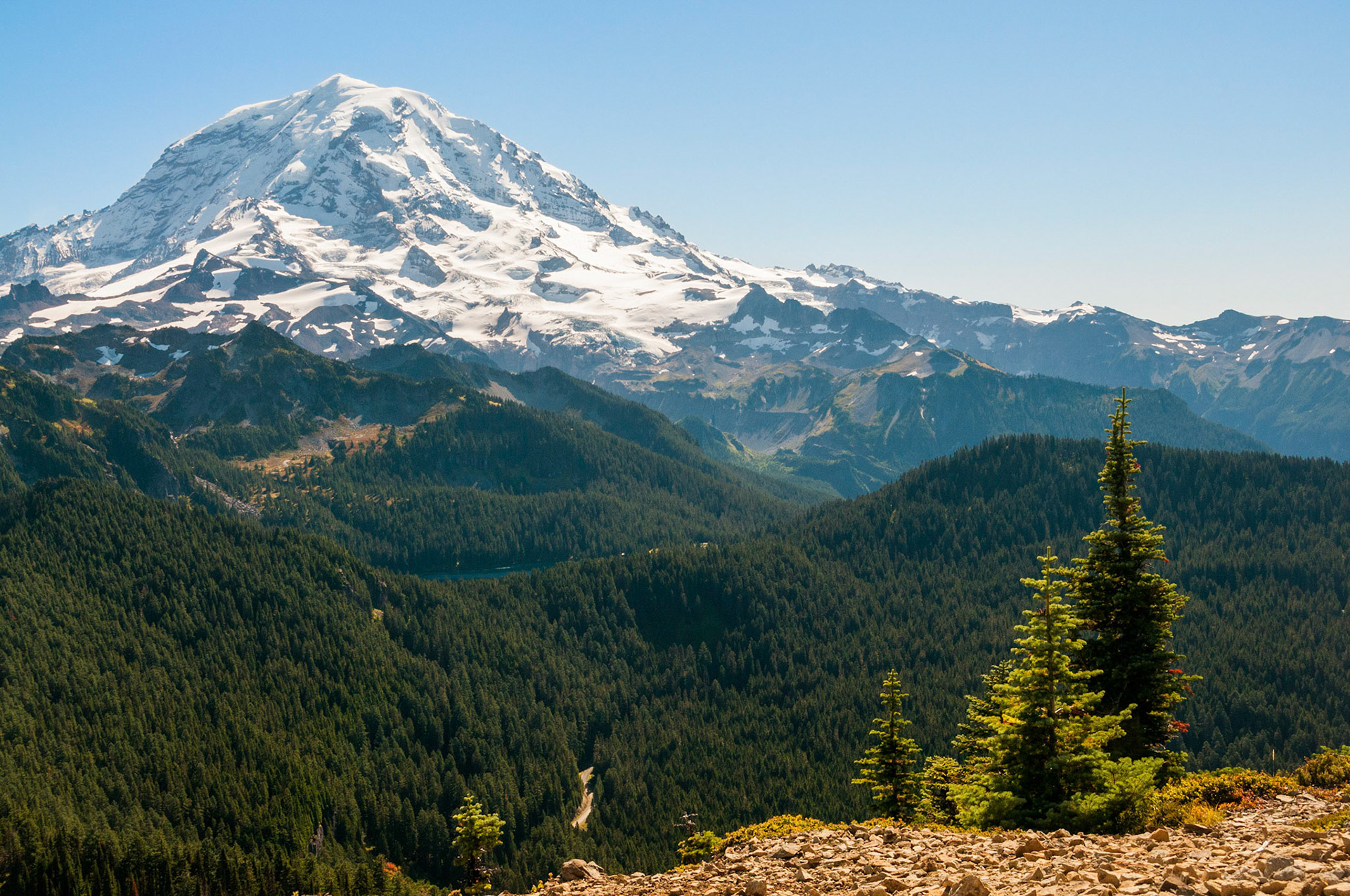 Sunny day scene hiking Tolmie Peak Lookout at Mount Rainier National Park in Washington.