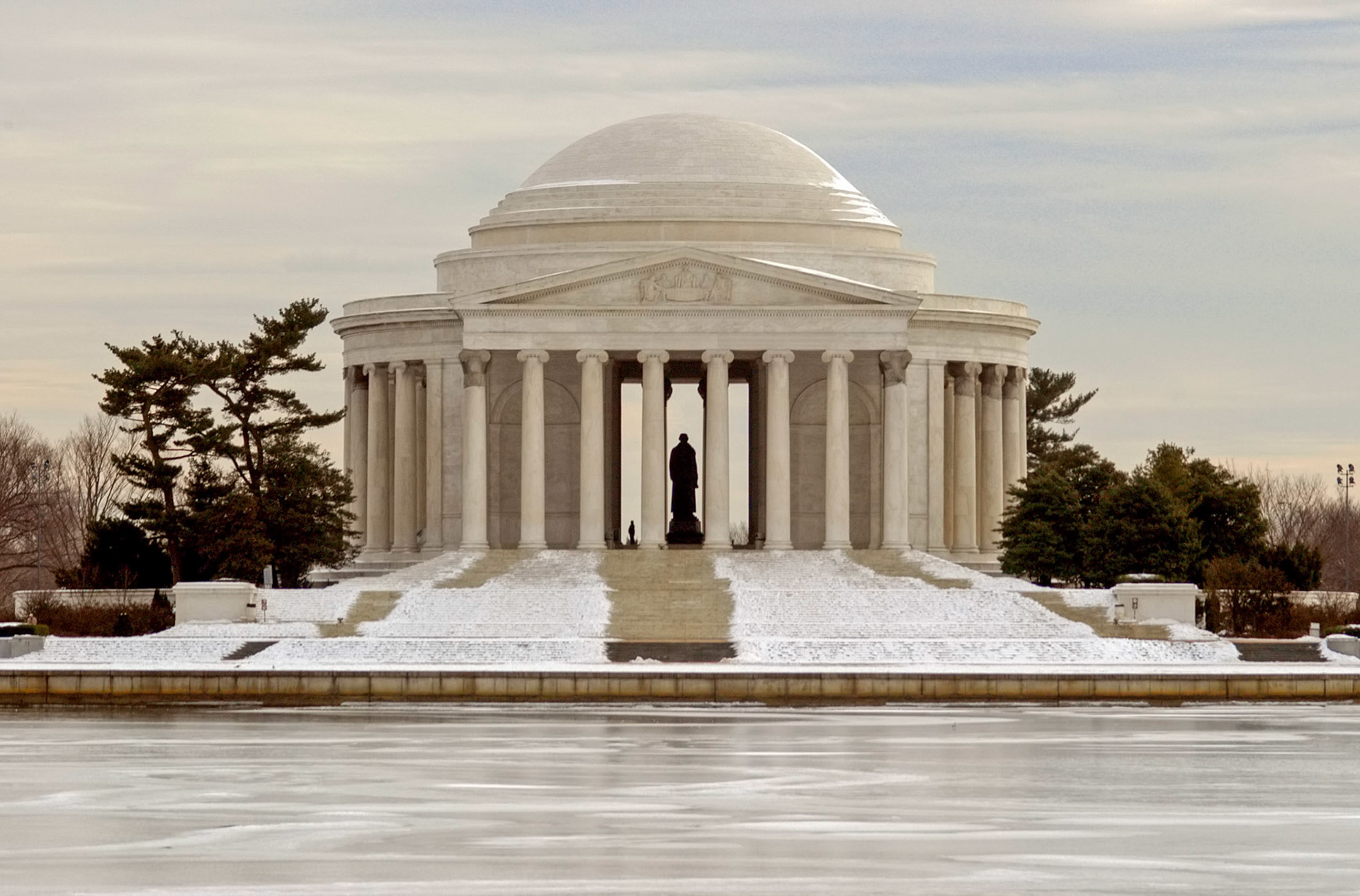 A tourist stands by the statue inside the Jefferson Memorial in Washington DC.