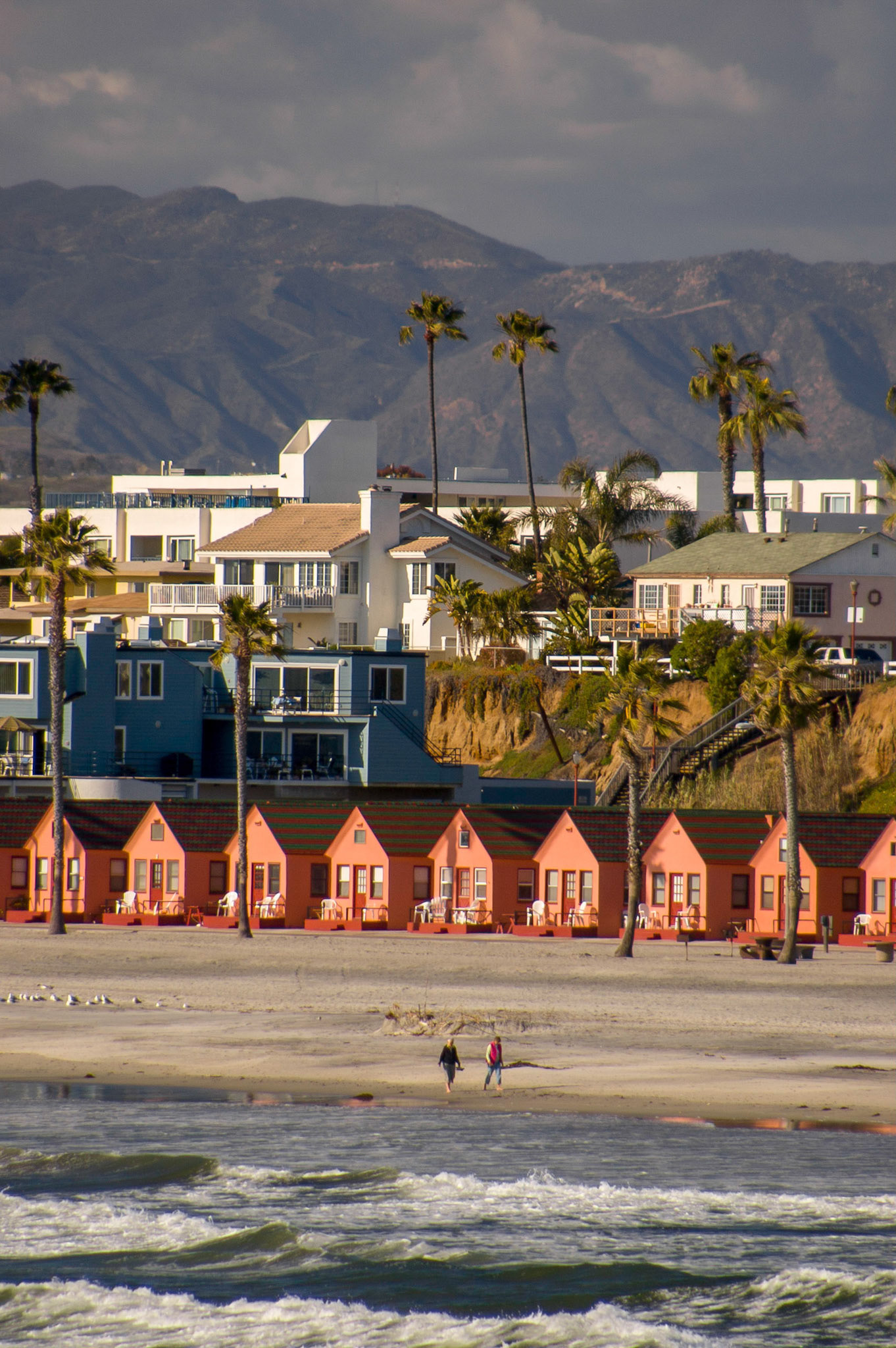 A row of orange beach houses along the beach at Oceanside CA.