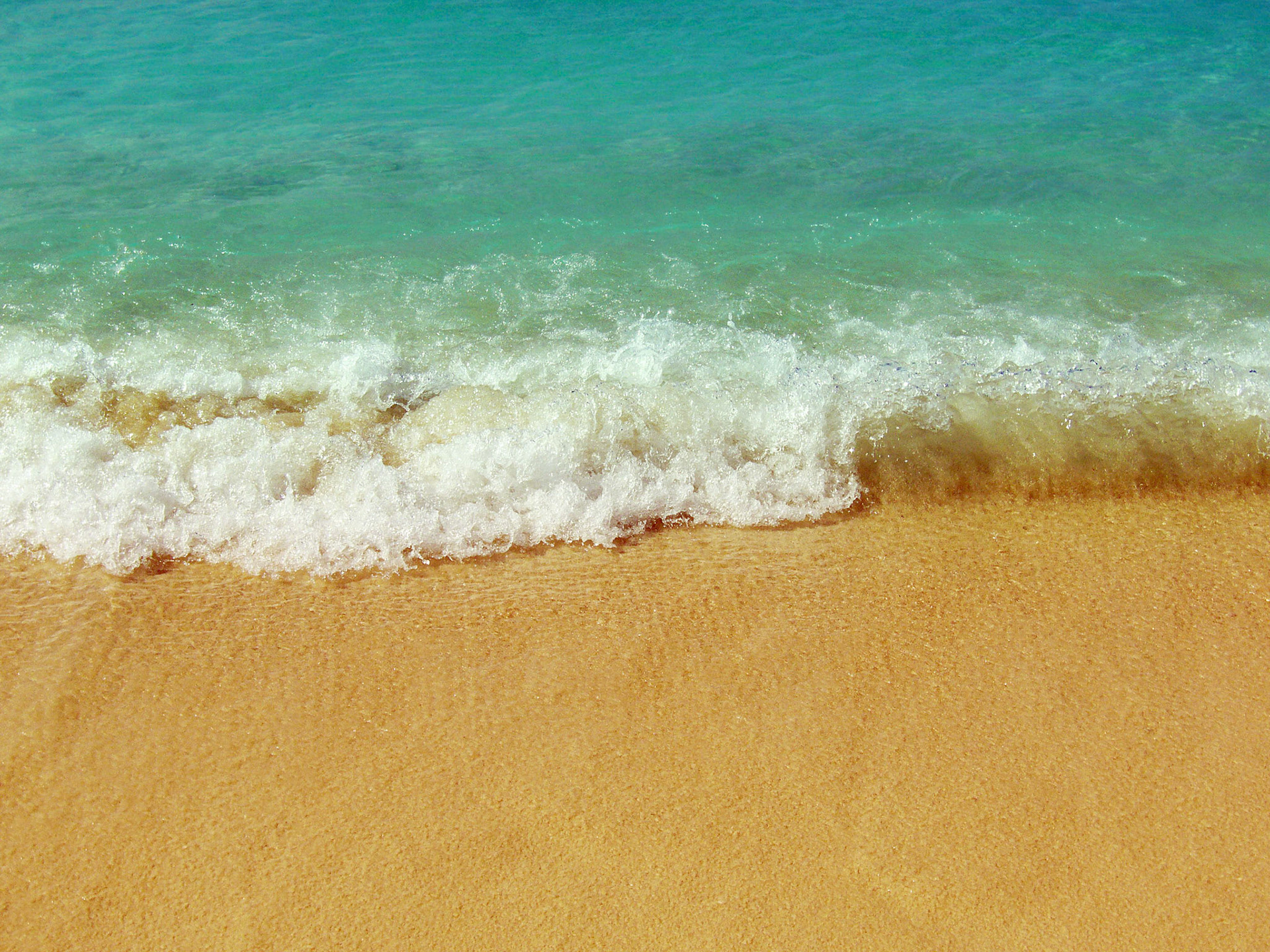 The sea meets the sand at Seven Mile Beach on Grand Cayman island.