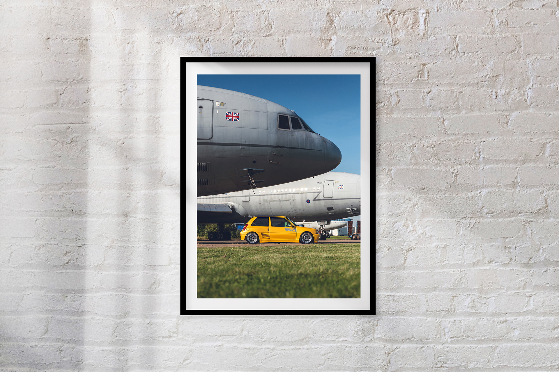 GOLD MEMBER: Tom Clarke's Max-Power era inspired restored Renault 5 GT Turbo in stunning Liquid Gold glimmers in the sunlight in front of contrasting grey military planes.