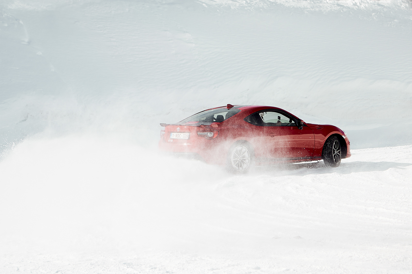 drifting car during on ice racing circuit in mountain landscape