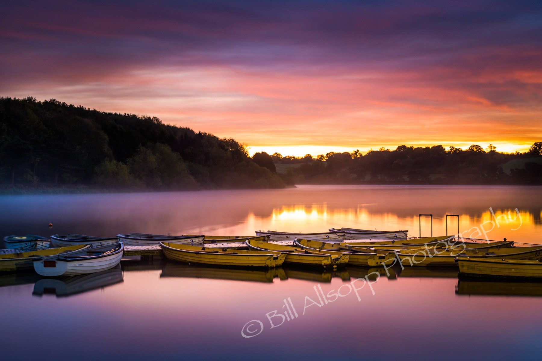 A new day dawns over the reservoir and the anglers boats.