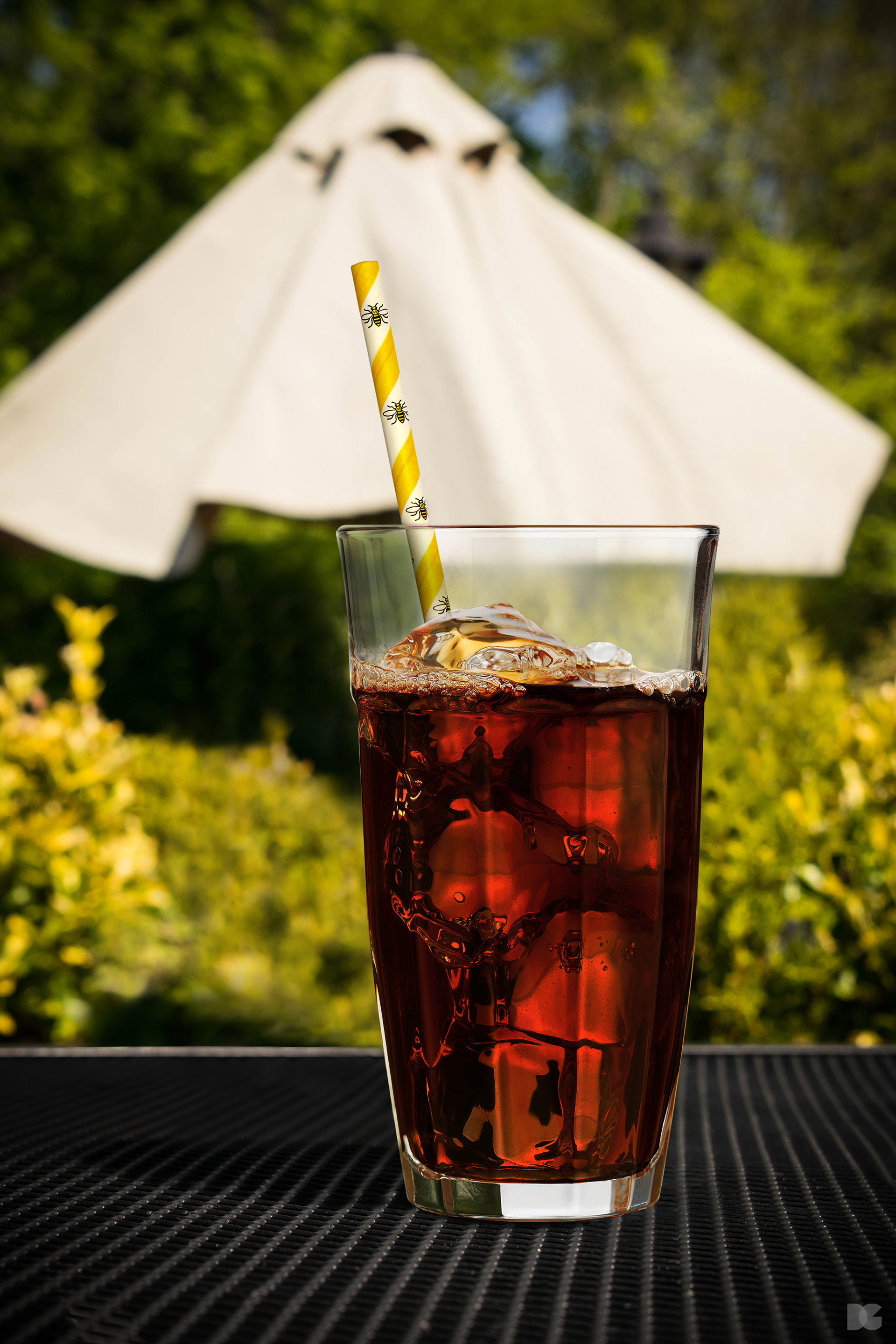 A composite image depicting The Manchester Bee Straw in a cola soft drink. © 2018 David Gilmore Design