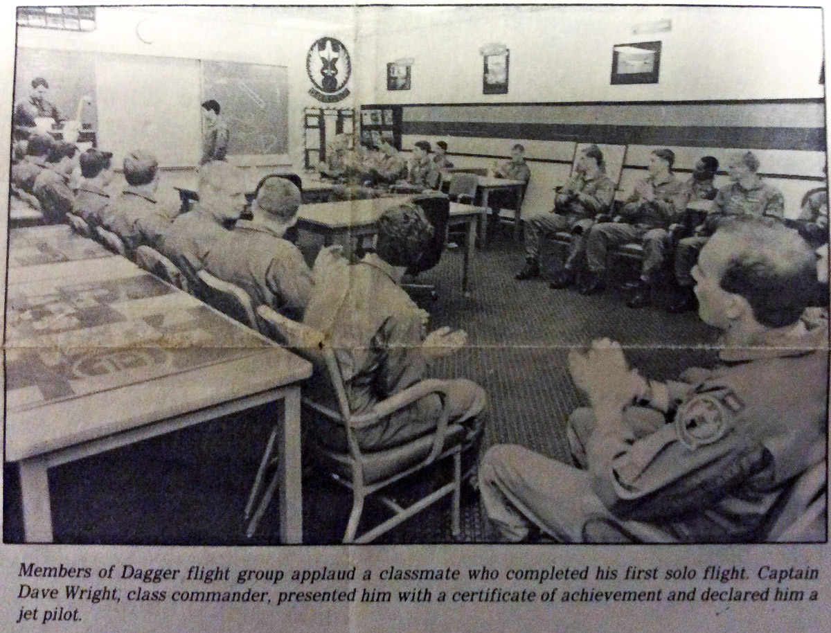 This is what the Dagger flight room looked like for the formal report and formal release. You can see a couple of decorated IP desktops on the left. At the front of the room, Captain Wright would stick a pink flamingo next to his podium whenever he wanted to motivate the troops. That’s me on the right, and even though the picture is not the best, you can clearly see why Three-Fingered Wayne could not cut me a flat-top.