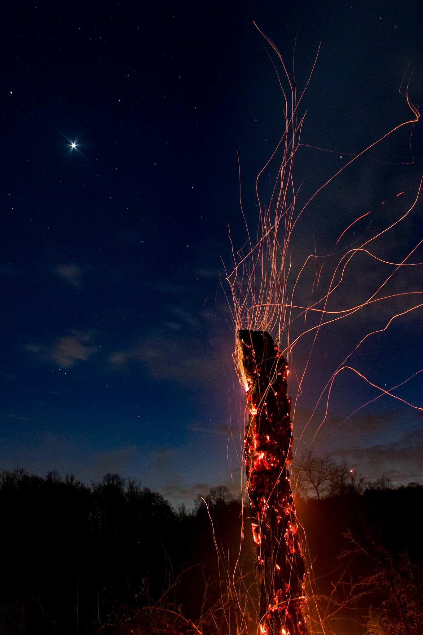Venus shines bright above the bonfire