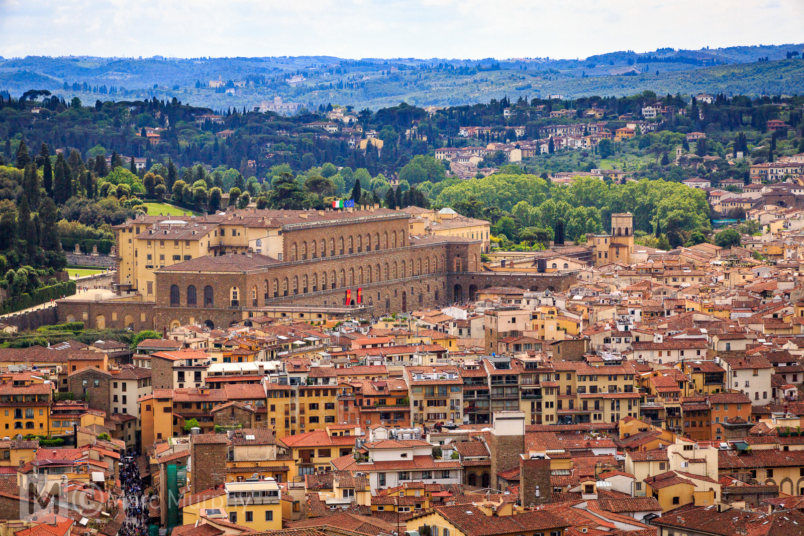 Florence Italy Pitti Palace or Palazzo Pitti in Spring from Elevated Position with Tuscan Buildings and Hills with Green Trees in the Distance