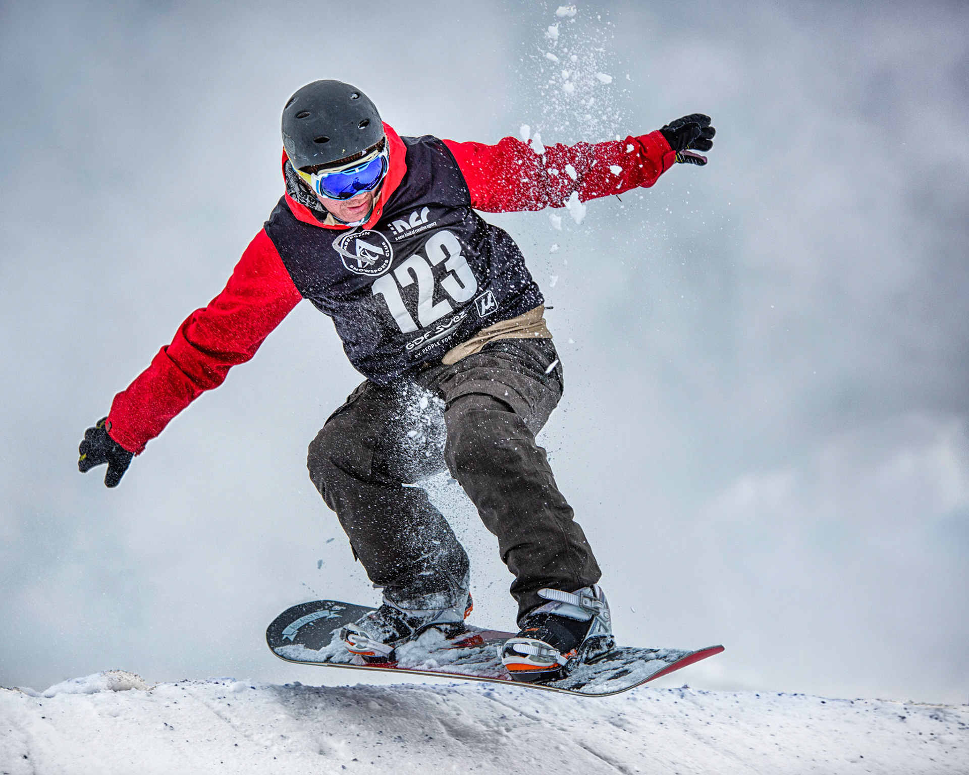When I'm not taking photographs I'm likely to be skiing. I combine both activities if I can. This was a Snow Cross competition at Glenshee, Scotland in March 2014. I captured this snowbaord competitor in the air over the crest of the first jump a few yards from the start line. This was a particularly steep jump which if taken too fast led to too much air and a hard, flat landing. This competitor got it spot on - just a little air and landed softly on the downslope.