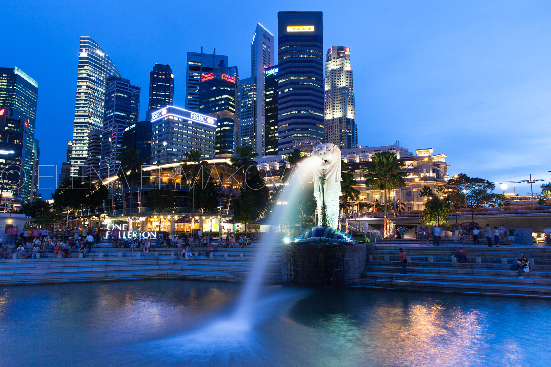Merlion fountain at dusk with CBD on the background, Singapore. Travel photography by Elena Ermakova.
