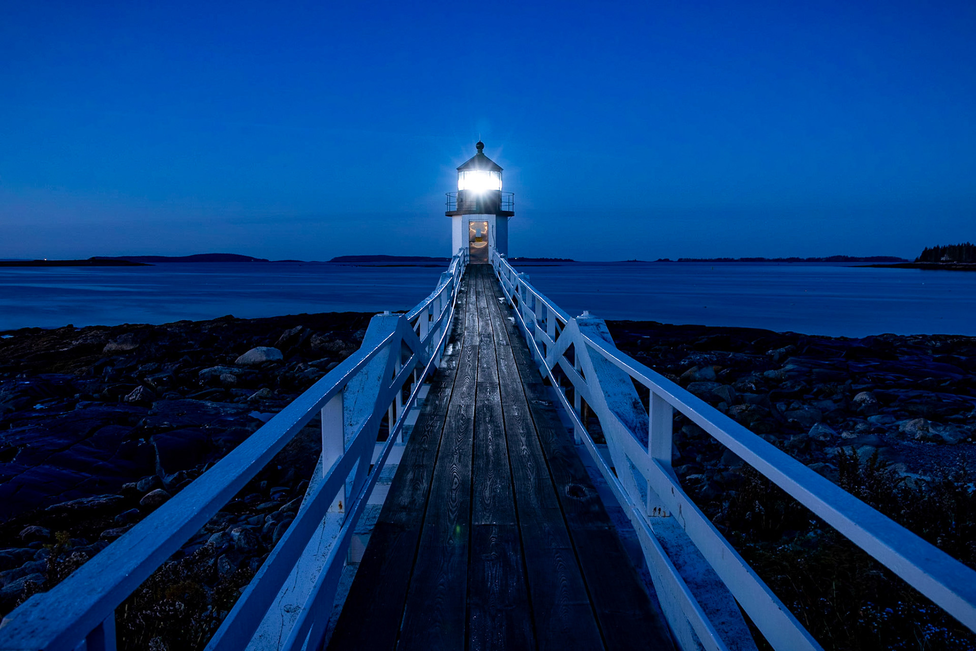 Established in 1832, the Marshall Point Light Station is a lighthouse at entrance of Port Clyde Harbor in Port Clyde, Maine. Photo taken pre-dawn looking out at the Atlantic Ocean.