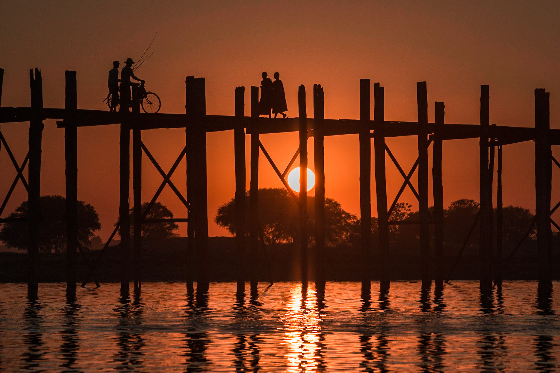 U Bein Bridge  is a crossing that spans the Taungthaman Lake near Amarapura in Myanmar. The 1.2-kilometre (0.75 mi) bridge was built around 1850 and is believed to be the oldest and longest teakwood bridge in the world. Construction began when the capital of Ava Kingdom moved to Amarapura, and the bridge is named after the mayor who had it built. http://en.wikipedia.org/wiki/U_Bein_Bridge
