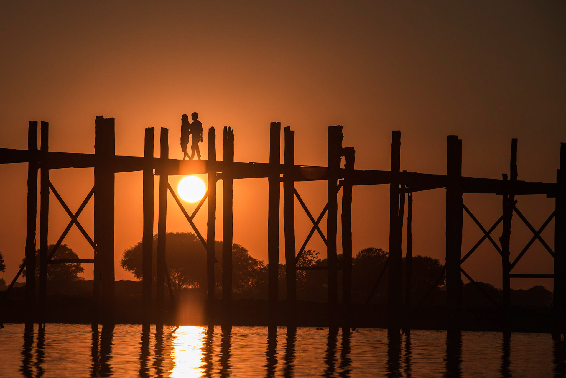 U Bein Bridge  is a crossing that spans the Taungthaman Lake near Amarapura in Myanmar. The 1.2-kilometre (0.75 mi) bridge was built around 1850 and is believed to be the oldest and longest teakwood bridge in the world. Construction began when the capital of Ava Kingdom moved to Amarapura, and the bridge is named after the mayor who had it built. http://en.wikipedia.org/wiki/U_Bein_Bridge