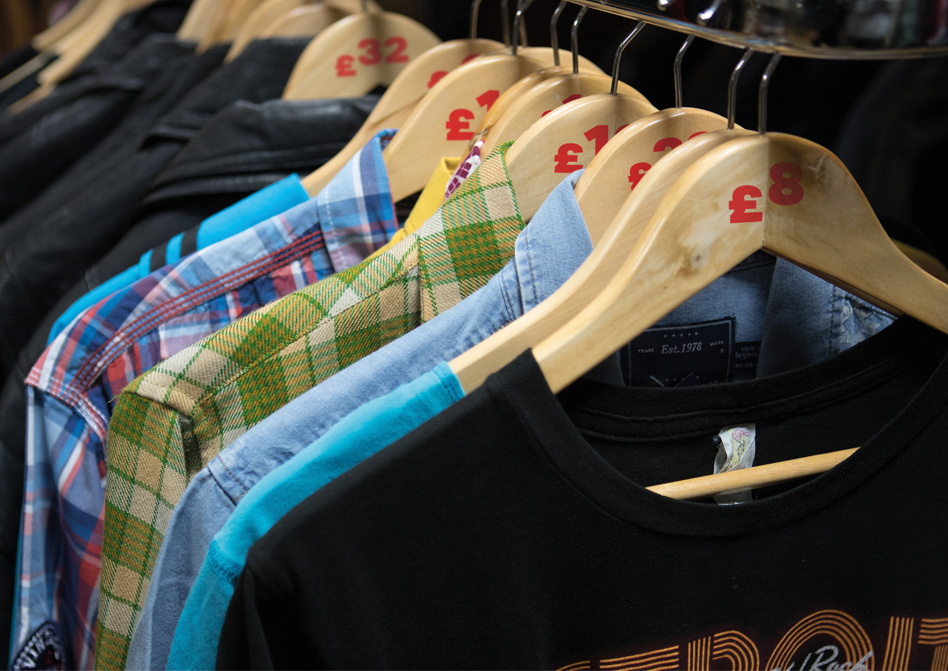 Clothes hangers with prices stamped on eliminating the waste from price tags.