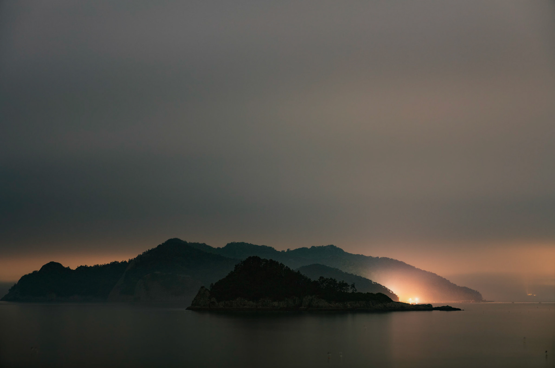 Saryangdo, South Korea - 02 MAY 2020: Stormy spring weather moves in and shrouds the islands around Saryangdo in haze and fog. This area is a popular destination for fishing and free diving for shellfish.