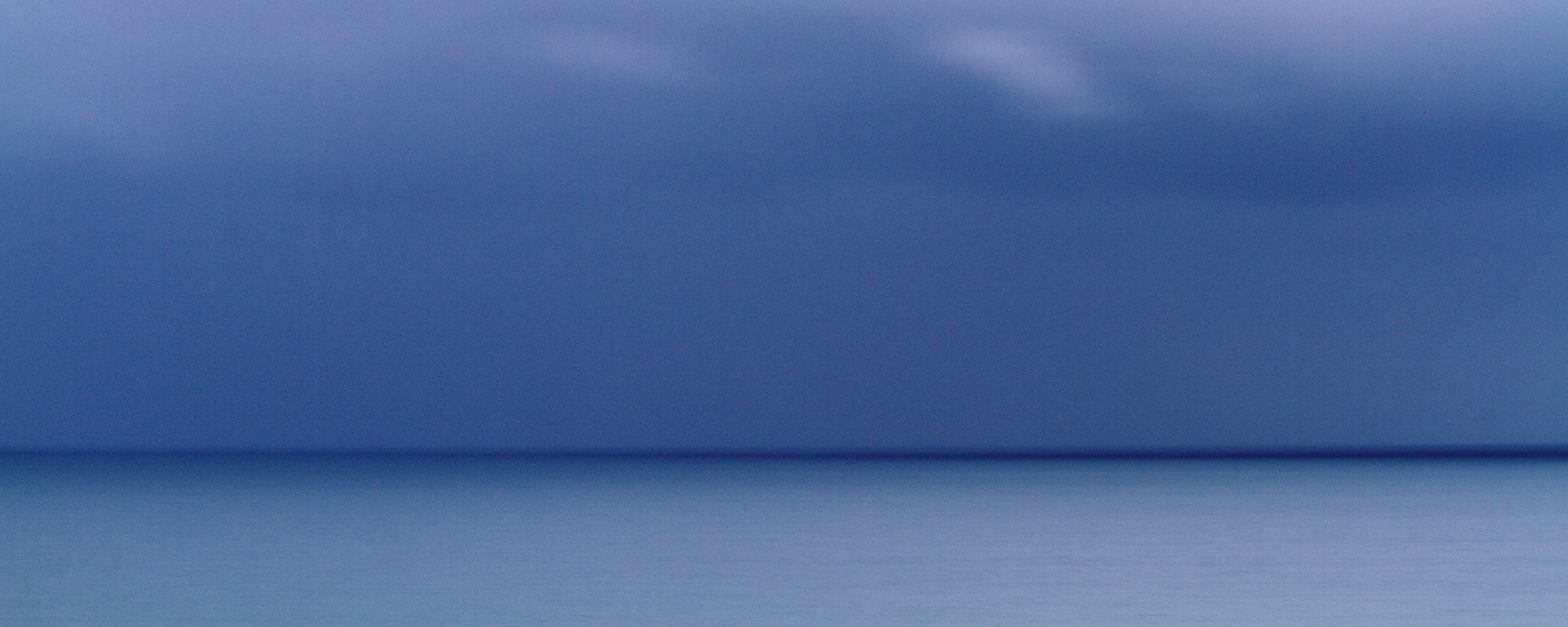 Deep blue sky, cloud and sea meet at an enhanced blue horizon, Cornwall, England, 2011