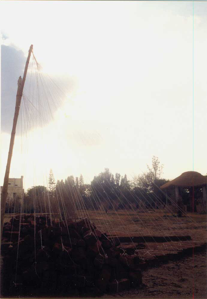Azis T.M , size: 20ft x 15ft x 10ft (approx) , medium: thread, bamboo poles, bricks, mud, pots and water.