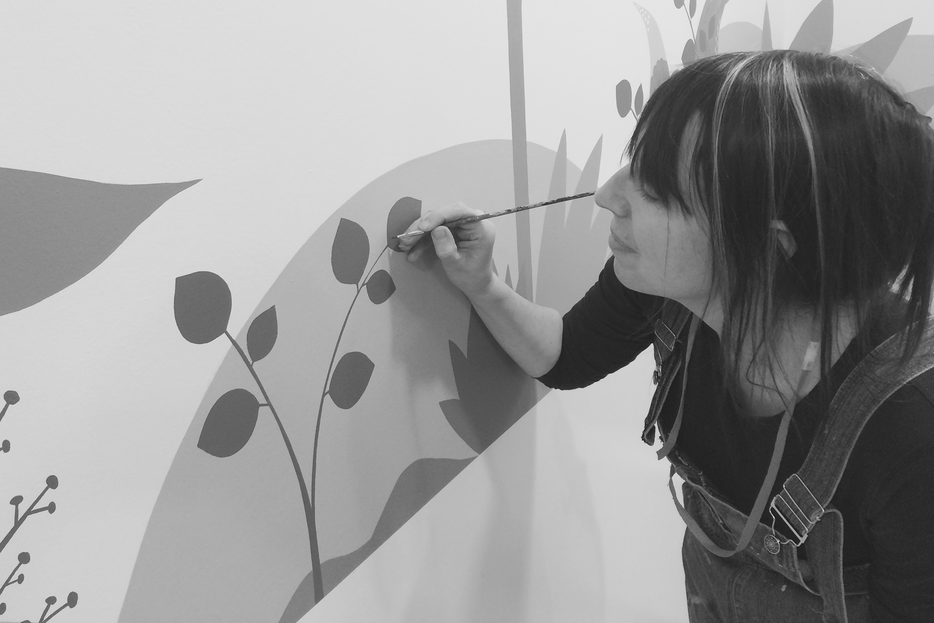 Lynne painting a mural