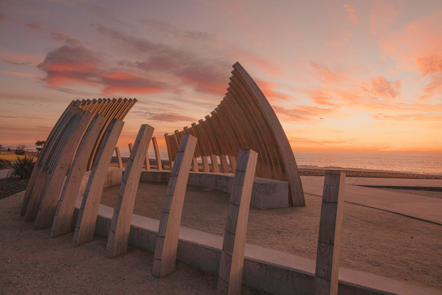 The Reef Garden's whale bones structure with the sun about to rise along the Marine Parade