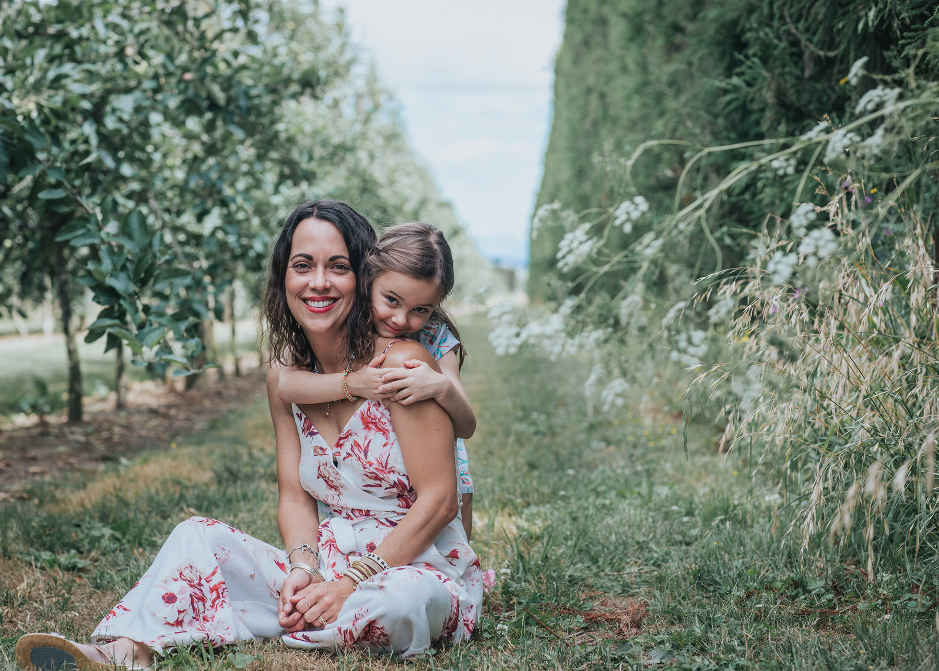 A mother and daughter siting in a Twyford apple orchard
