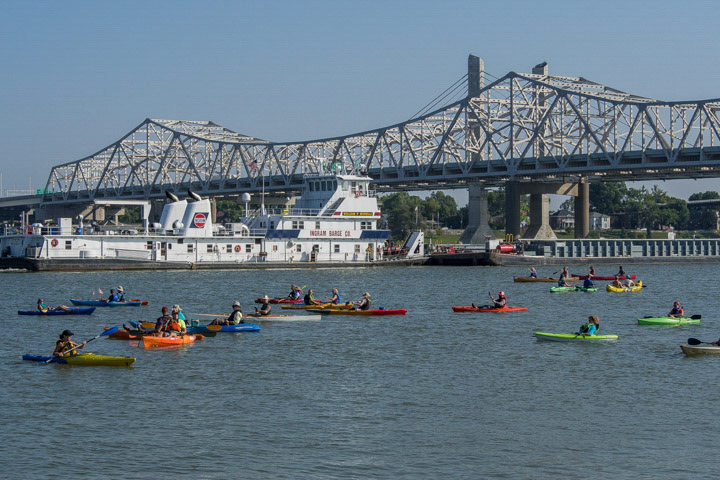 Paddlers waiting on a barge to pass.