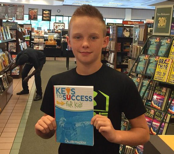 Caleb Maddix with his book- I designed the cover