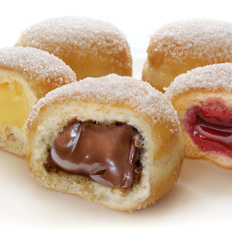 Photo rapprochée des beignets avec fourrage chocolat, vanille et framboise.