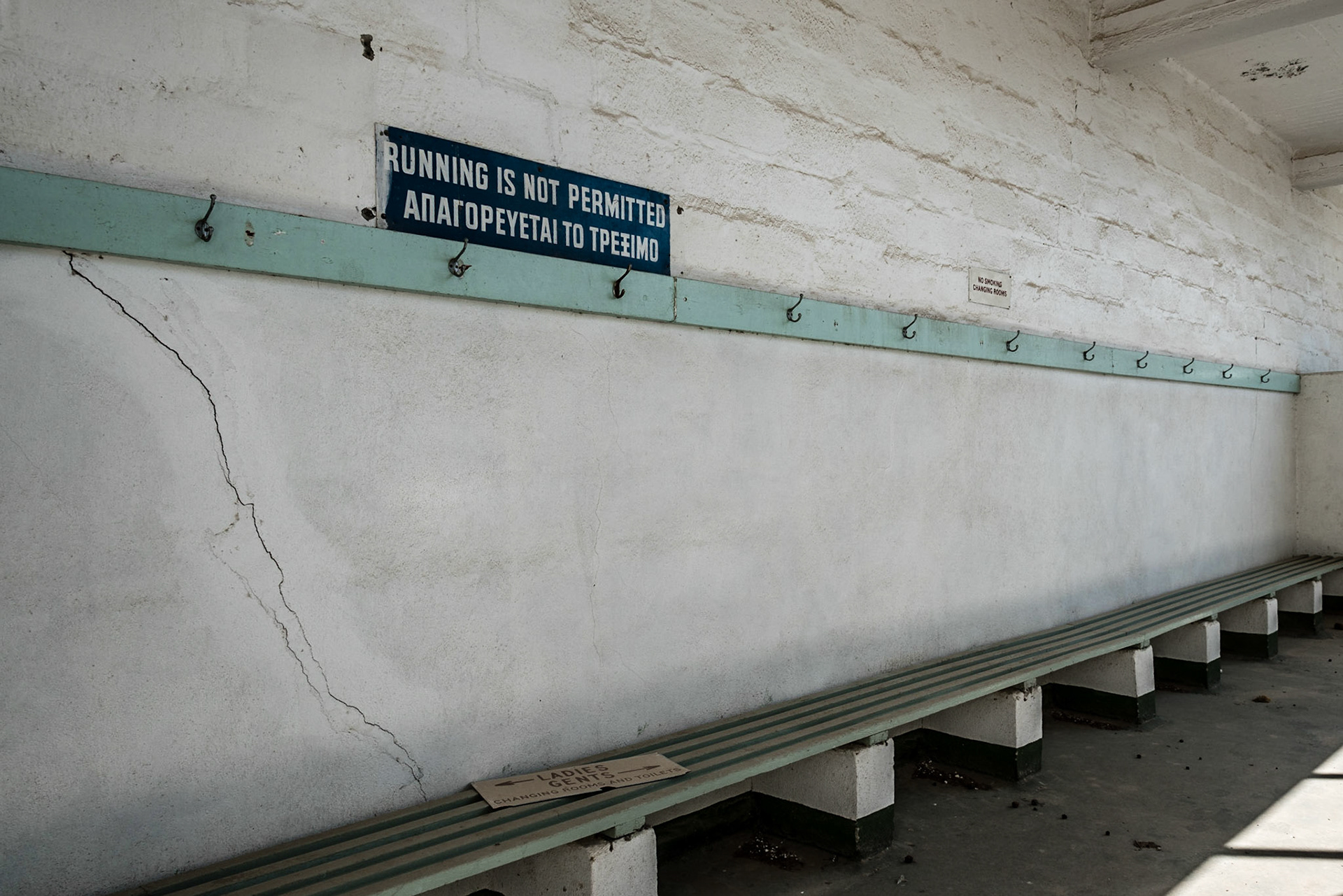 Sign in the swimming pool changing rooms at the abandoned Berengaria Village in Limassol, Cyprus
