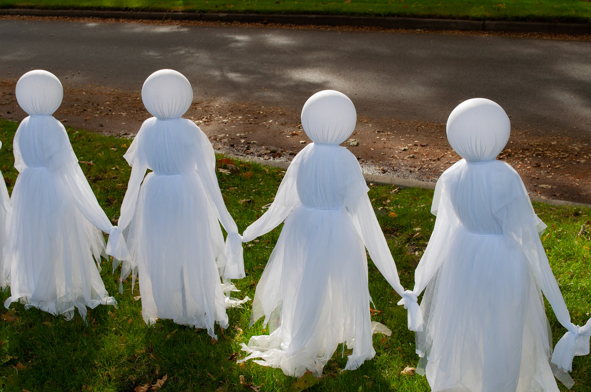 Ghosts: Halloween ghosts, captured this amazing balance of light/shadow and color as the light peaked through the trees onto the ghosts, 20201011, Harrison Blvd, MILLER, I enjoy this time of year and this particular street very much and capturing the the way the light was formed around the round heads and passing through the sheerness of the fabric. Camera Settings: Nikon D5000 ISO 200, 36mm f/10, 1/80s