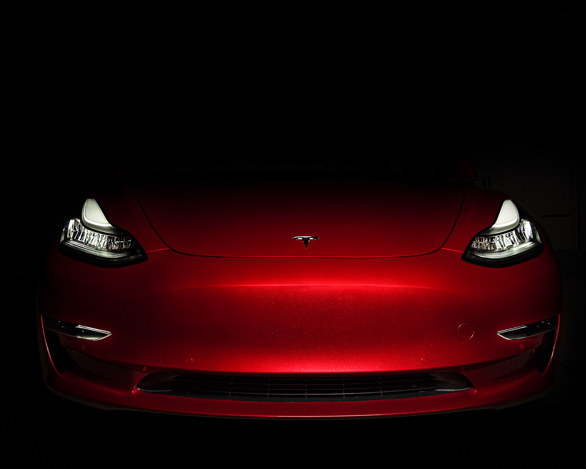 Red Tesla Model 3 at Night