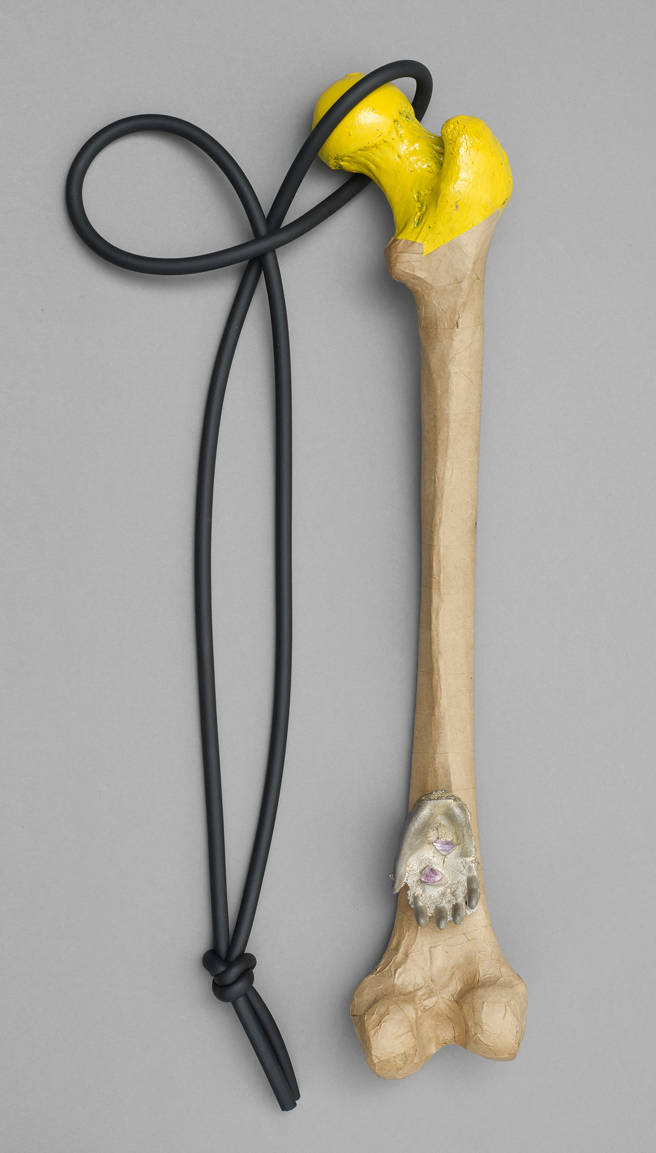 No.1 Item: Pendent H 47cm W 10cm D 7cm Materials: decommissioned museum bone, recalled paint, rainfall on Friday 13th, brown paper, pewter, amethyst, rubberPhoto credit: Michael Pollard