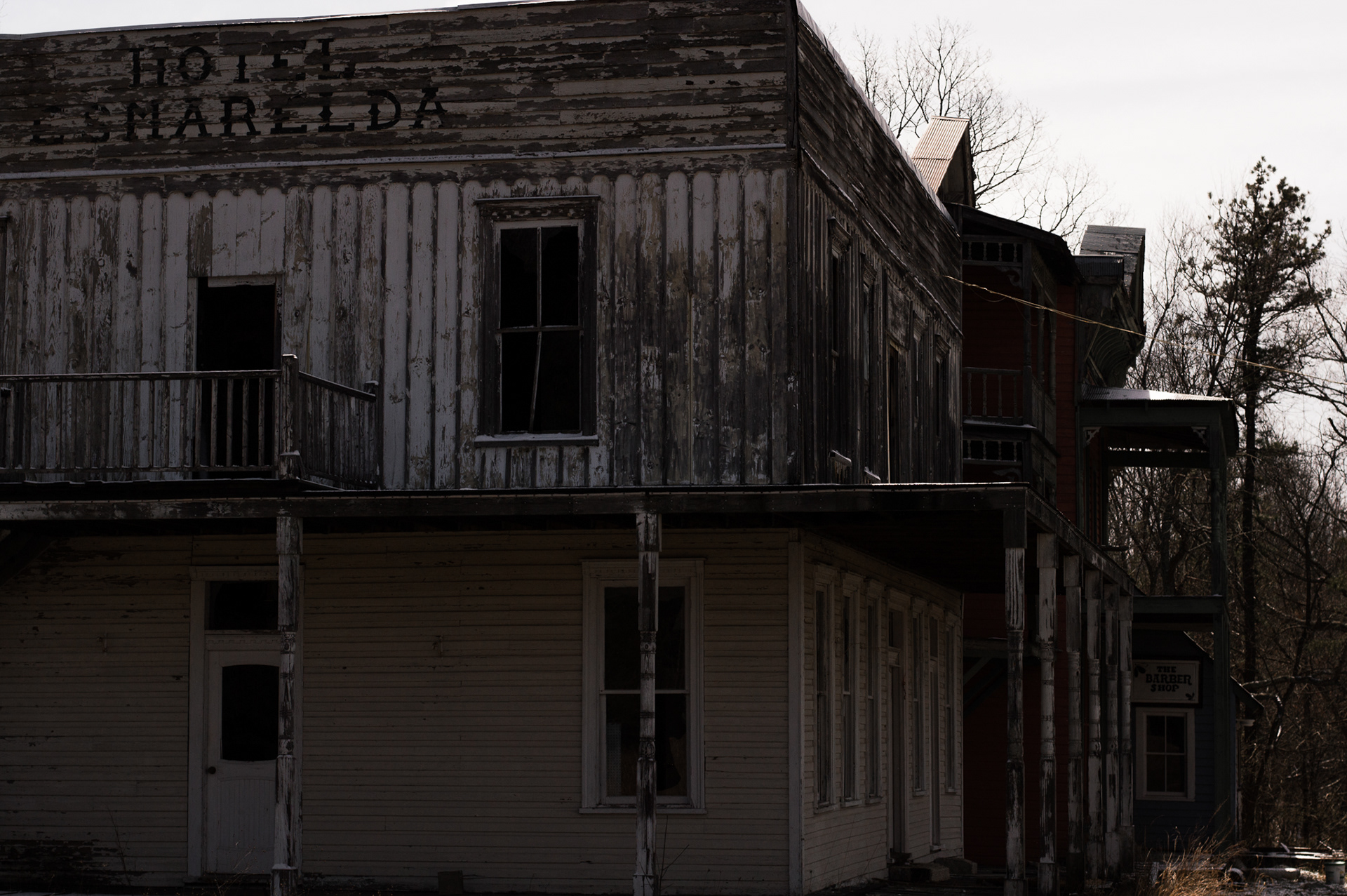 An abandoned hotel, with a sign saying Hotel Esmerelda.