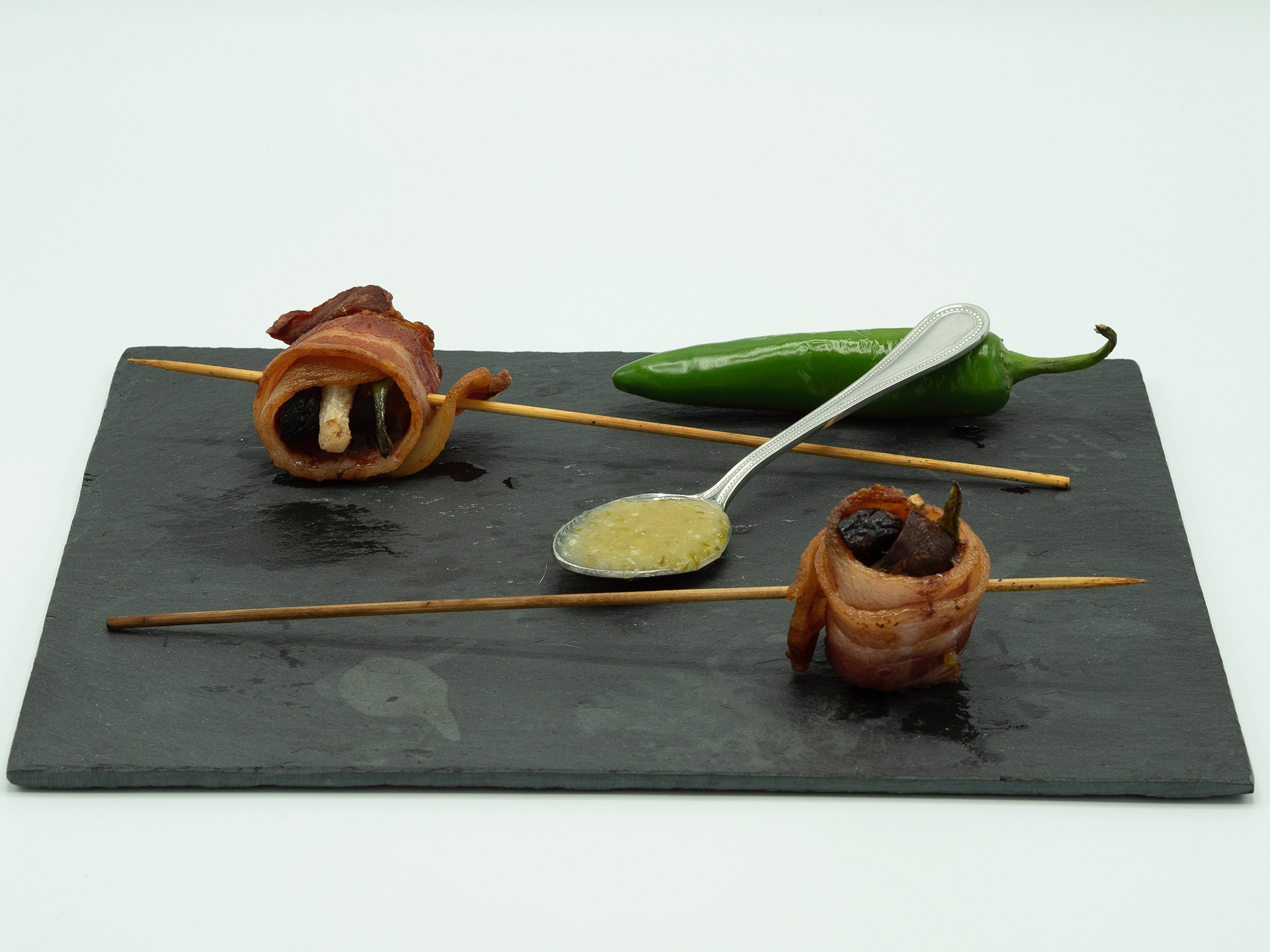 Duck Diablos - Duck medallions, balsamic vinegar macerated figs, jicama, wrapped in bacon with Thai sweet chili dipping sauce
