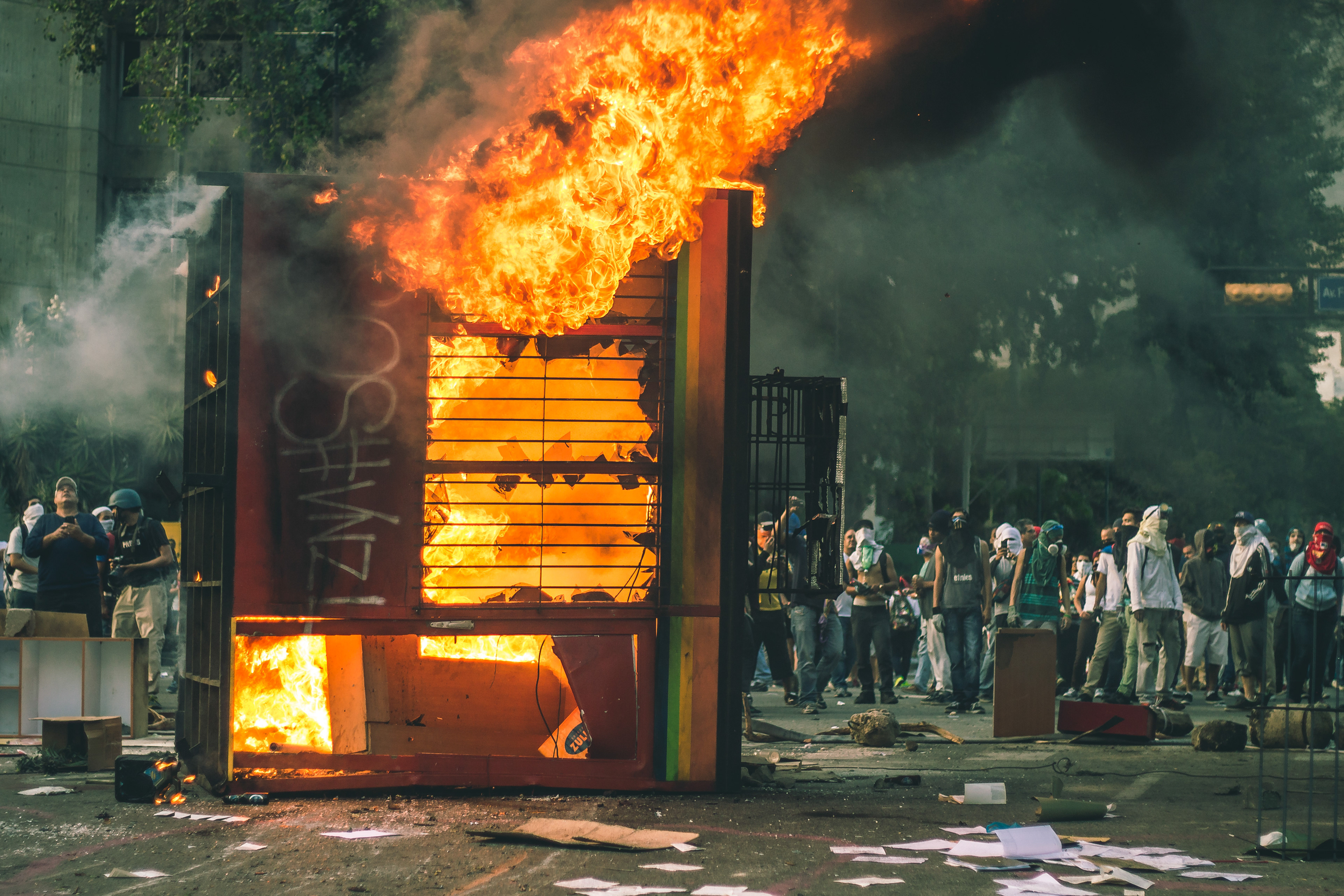 A bus booth is set on fire by protesters and used as barricade. Caracas 2014