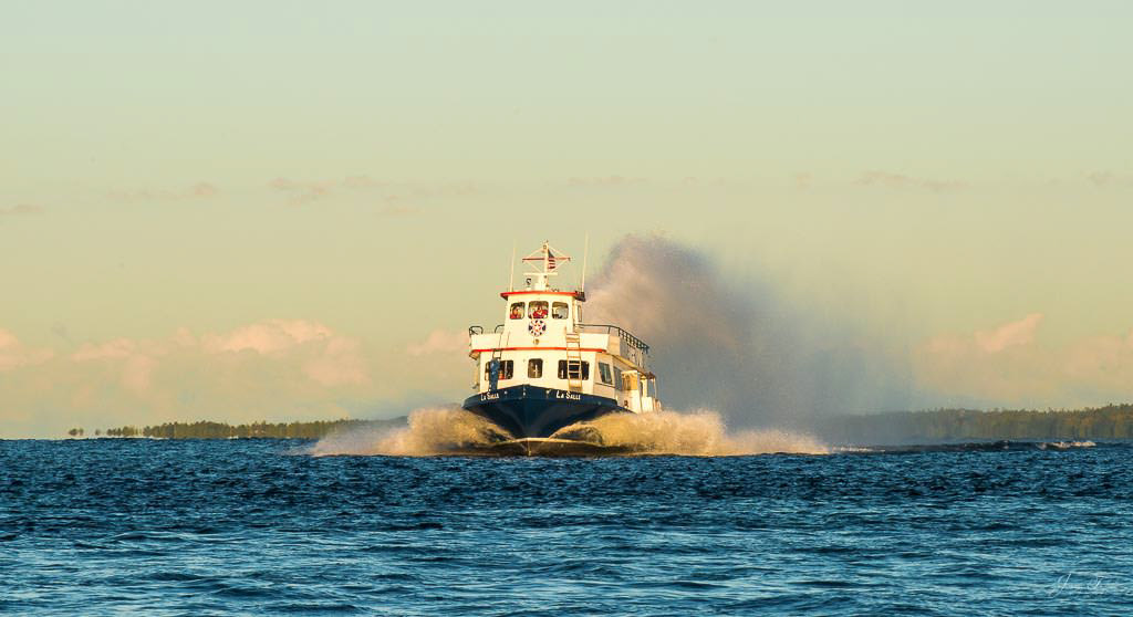 Mackinac Island sunrise with approaching ferry in the distance