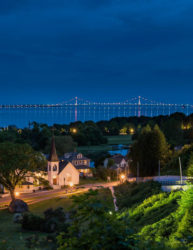 Mackinac Island at night, beautiful view from high above. Mackinac Bridge in a distance.
