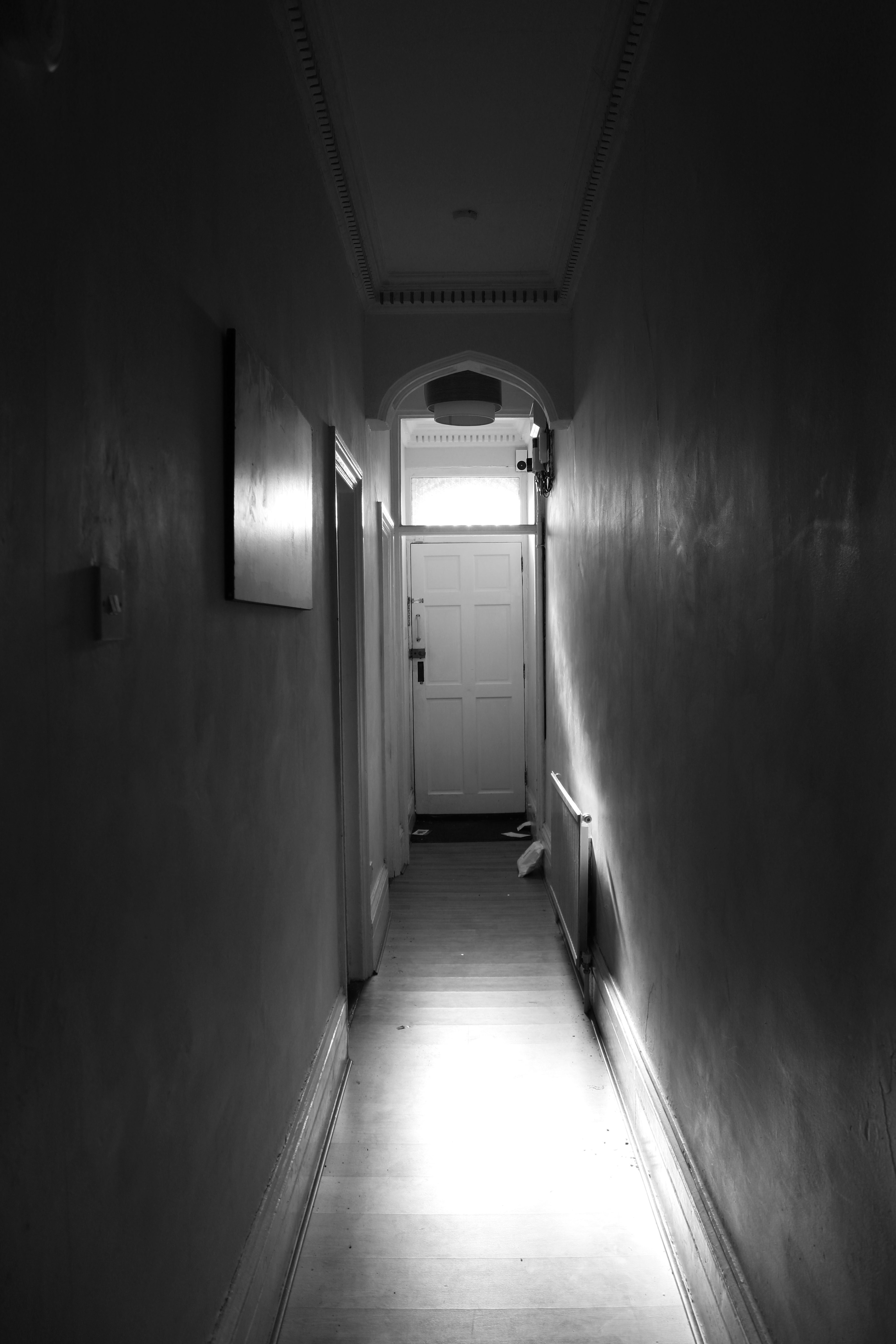 Long hallway with light beaming longingly through the window