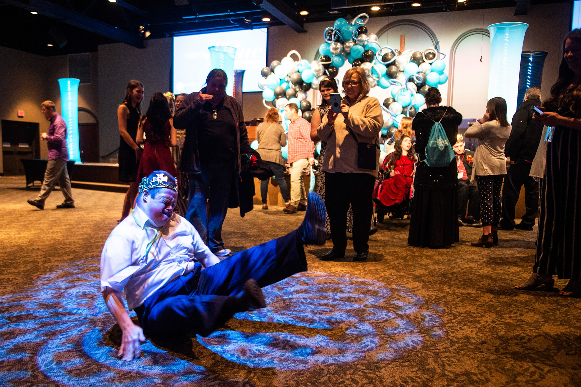 Oscar Dishon, left, breakdances in the spotlight at the conclusion of A Night to Shine, part of the Tim Tebow Foundation, on Friday, February 7, 2020, in Decatur, Ala.