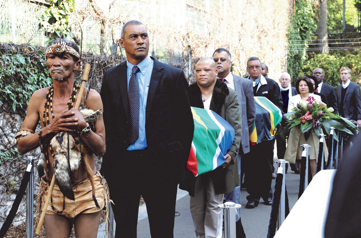 Traditional San healer Petrus Vaalbooi leads the exit of the coffins from the South African Embassy in Vienna on April the 19th 2012. Petrus Vaalbooi, Shane Christians, Abel Pienaar, Ciraj Rassool, Cecil Le Fleur, then cut off most likely Xolisa Mabhongo, next to him Pauline Williams and behind them Martin Legassick and Vusi Ndima and at the very back Niel van Zyl.