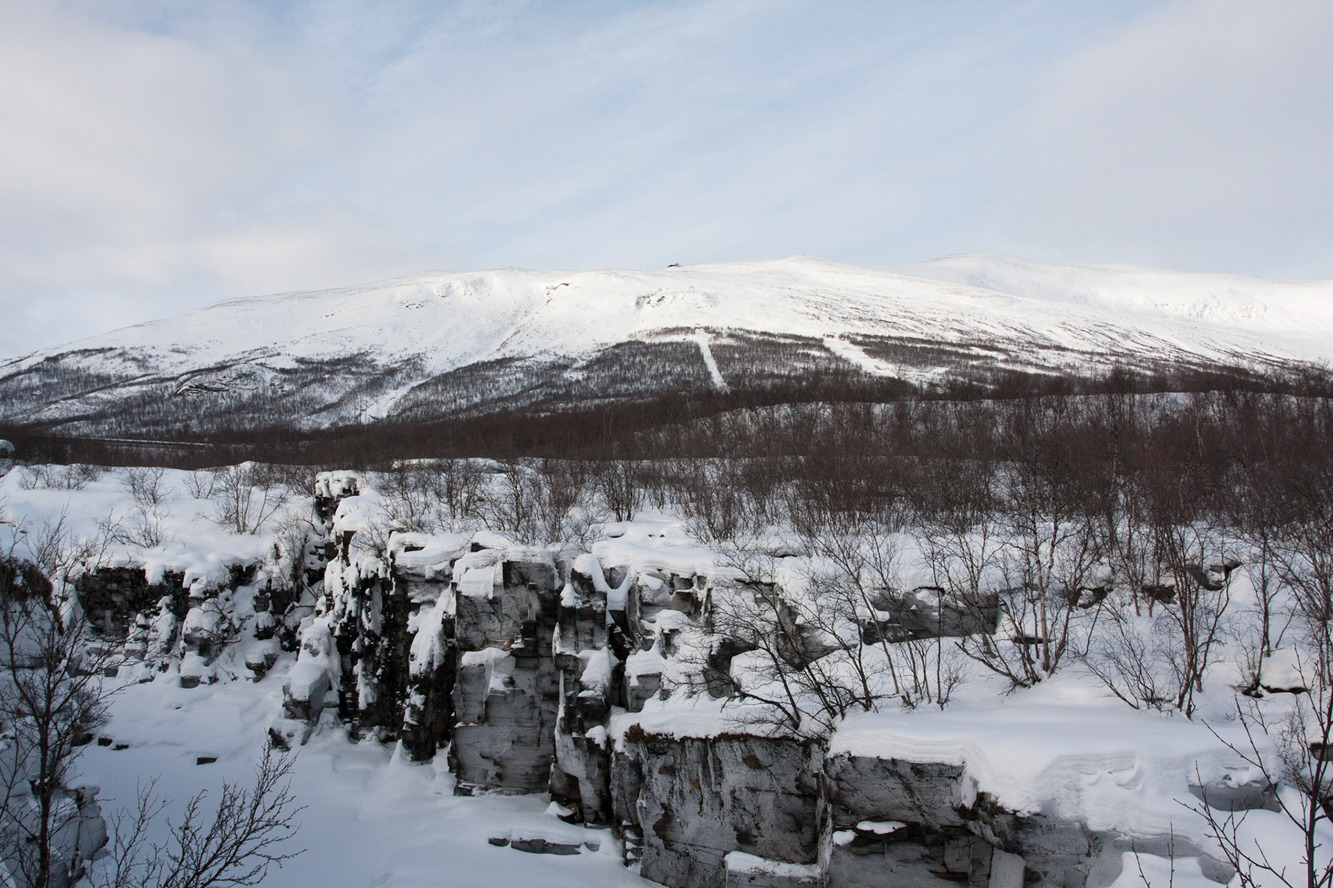 Frozen river and mountains at Abisko