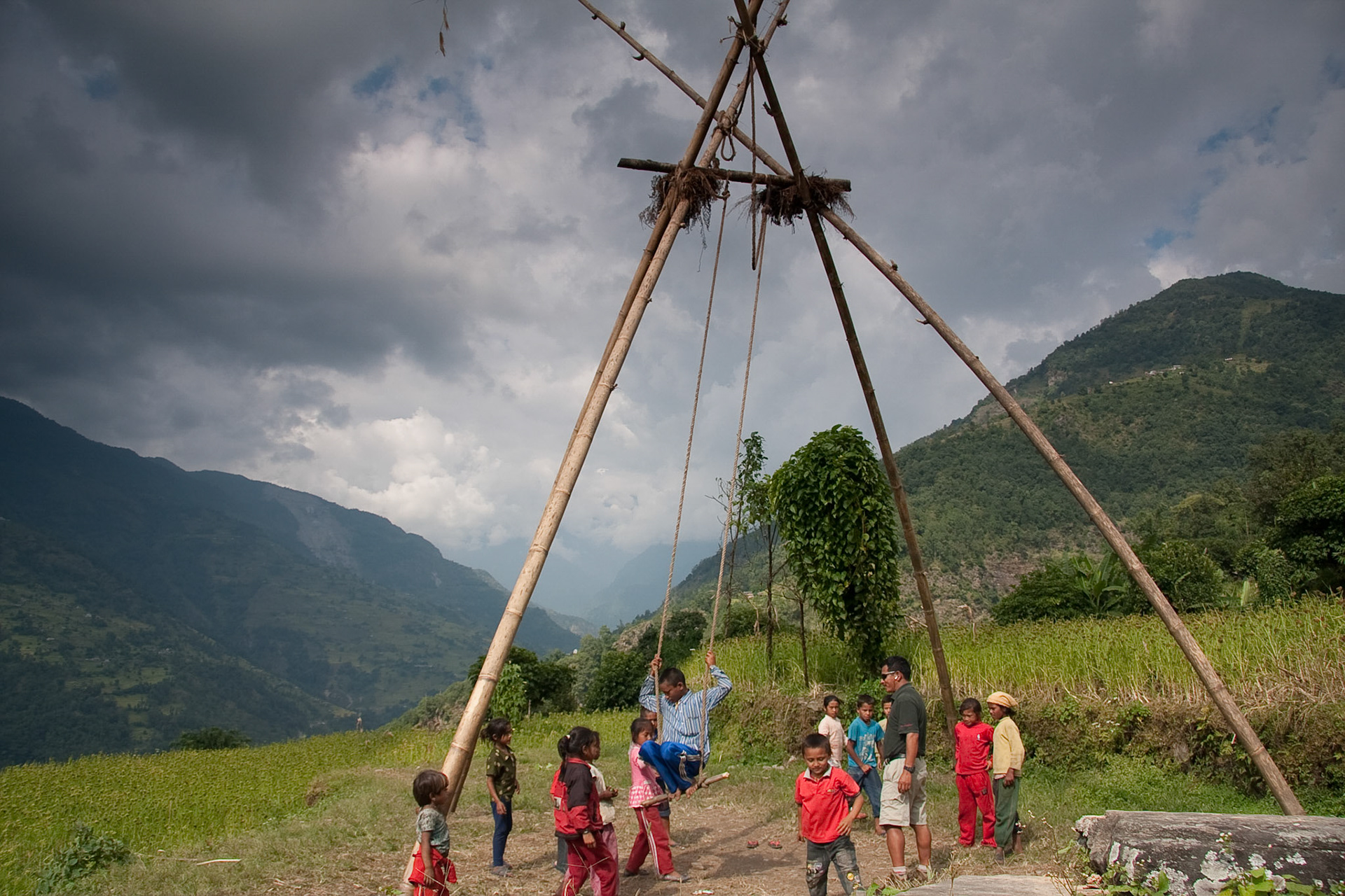 Children playing on a bamboo swing built for the festivals