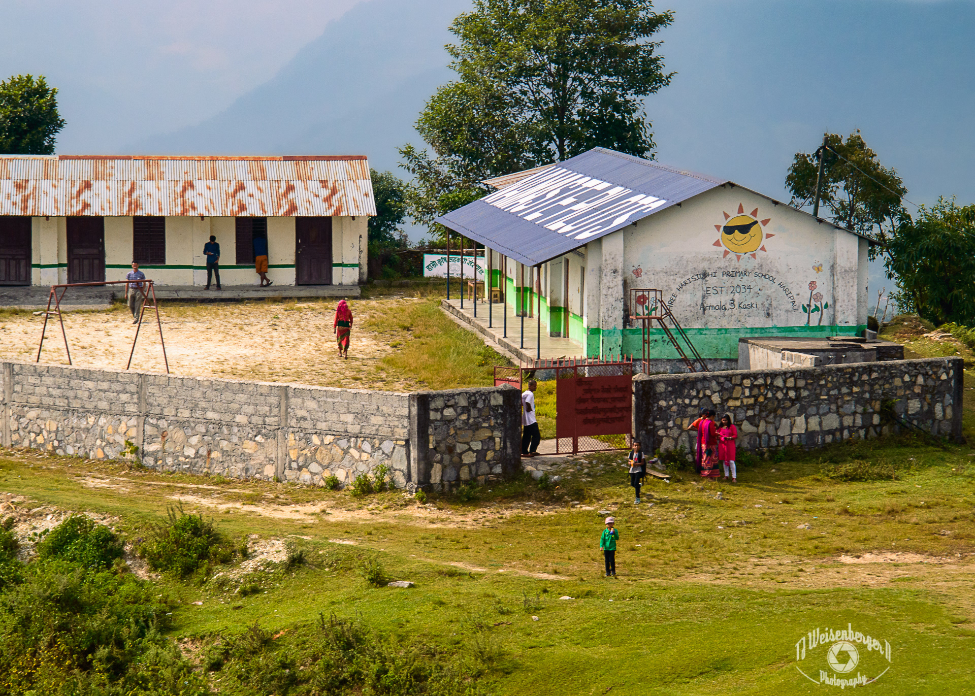Namaste Pilots, Shree Harisiddhi Primary School Haripau, Paragliding - Armala, Kaski, Pokhara, Nepal; Aerial Photography; Aerial View; Landscape; Landscape - Scenery; Mountain; Mountains; Namaste Pilots; Nepal; Paragliding; People; Photography; Planet Earth; Pokhara; Rural Scene; Scenics - Nature; School; Sunny; Tourism; Travel Destinations; Village; aerial; outdoors; rural; TJ; Weisenberger