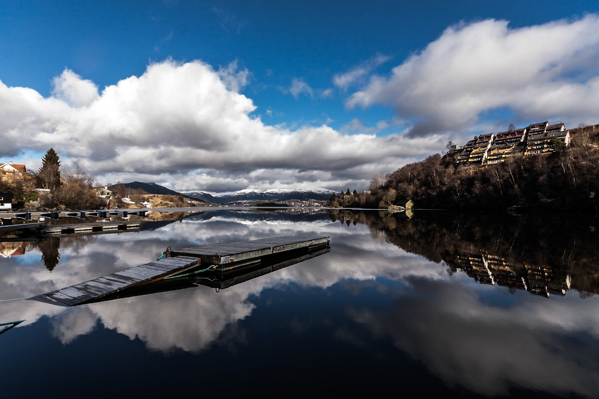A floating dock on the calm and reflective blue water