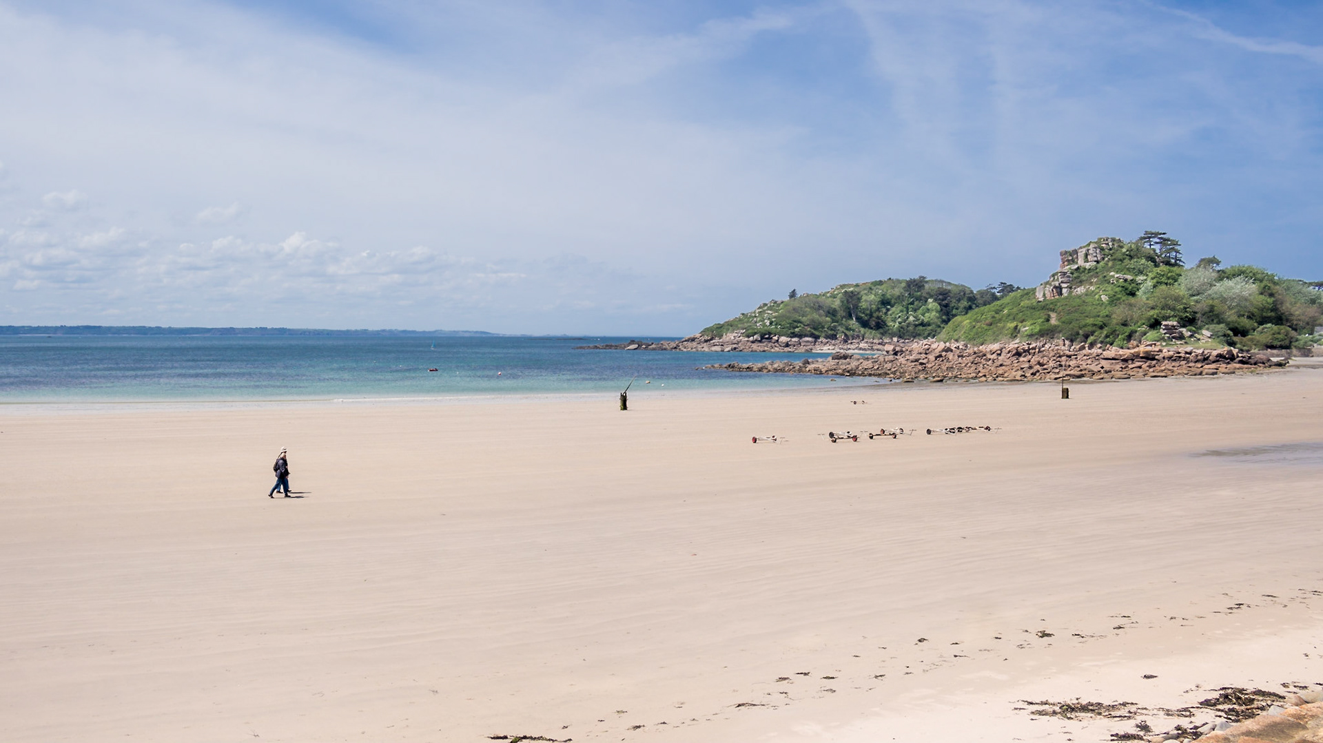 Pale pink sand on the beach of Trébeurden, Bretagne. Ile Milliau in the background.