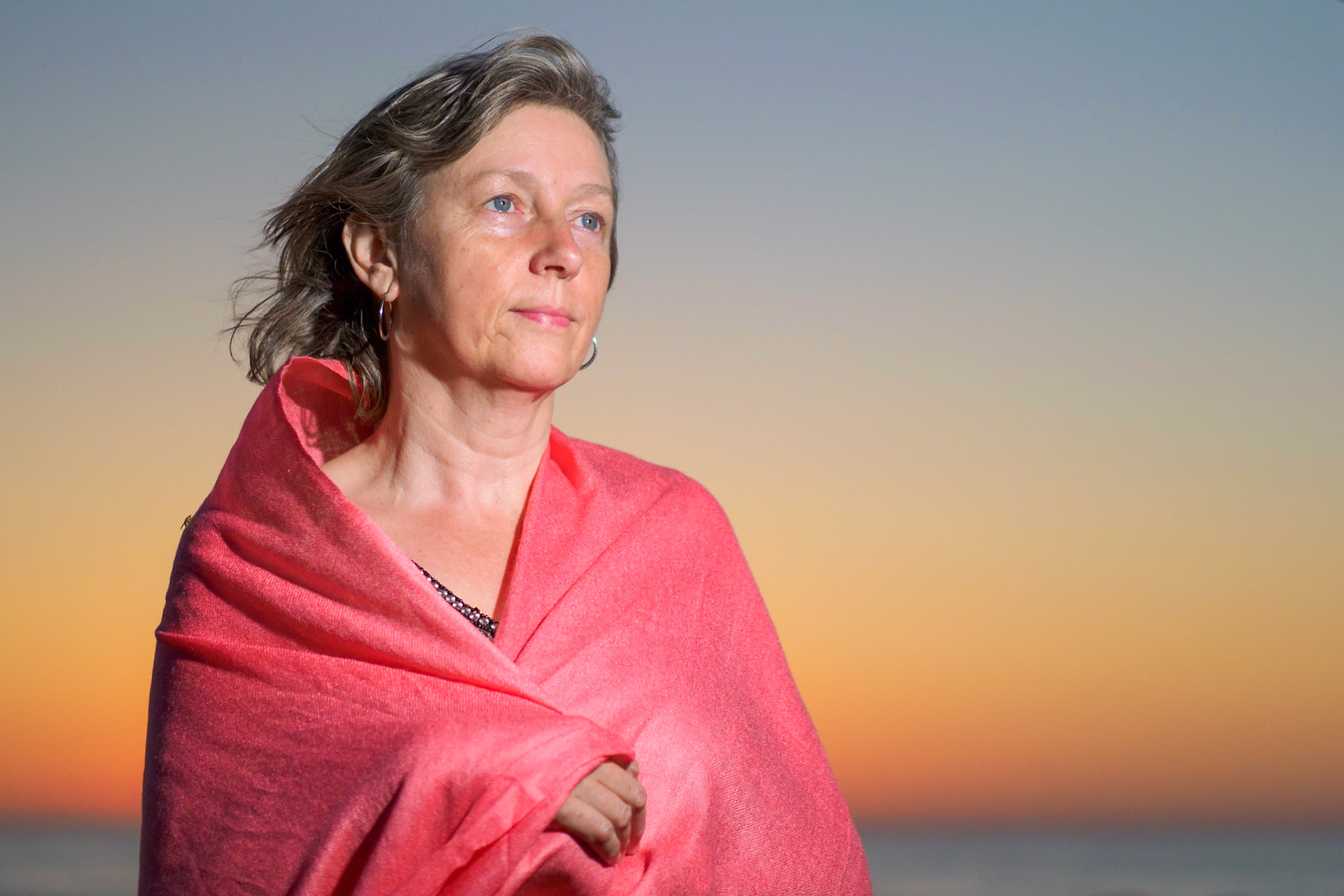 Adult female with pink scarf on the beach X