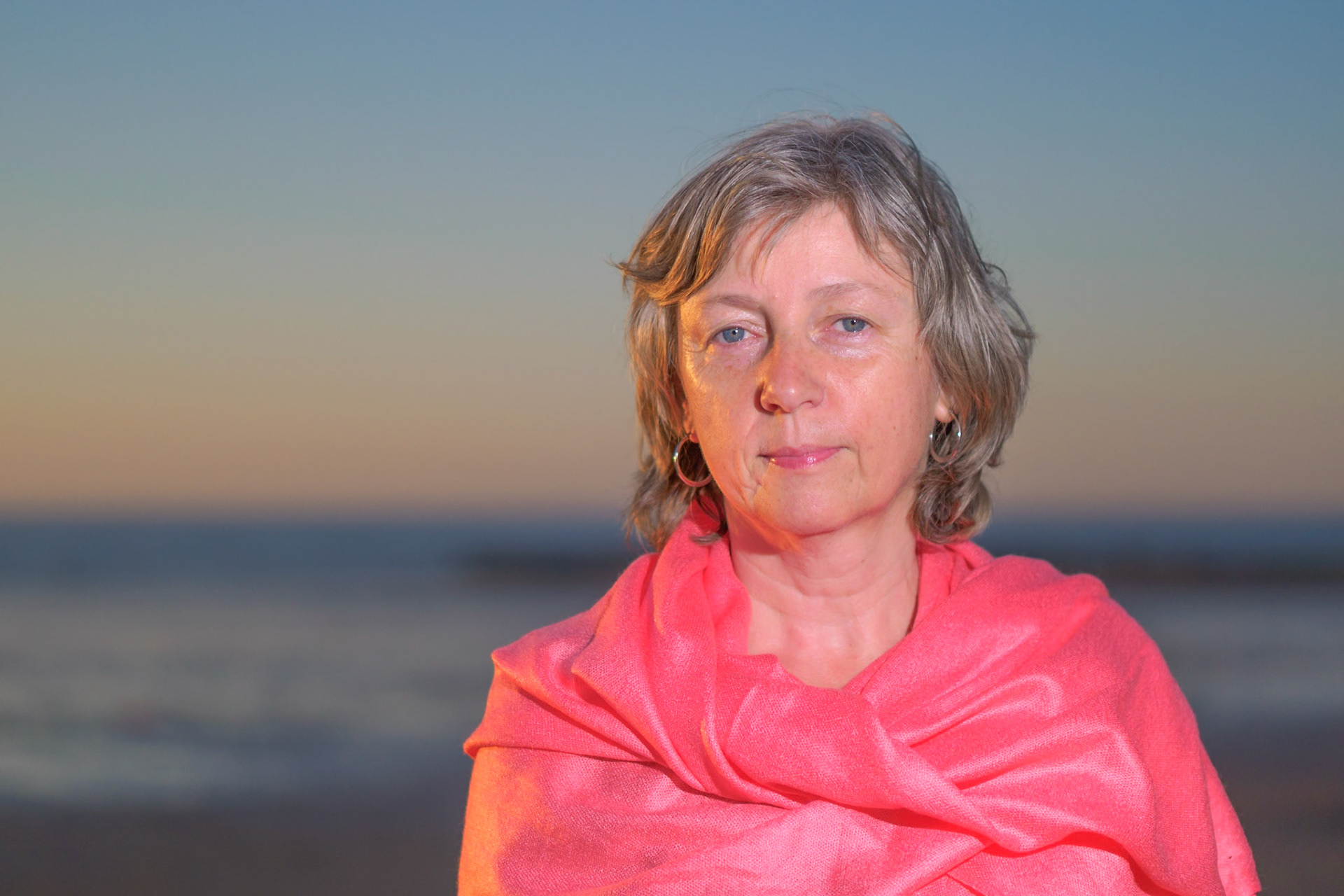 Adult female with pink scarf on the beach III